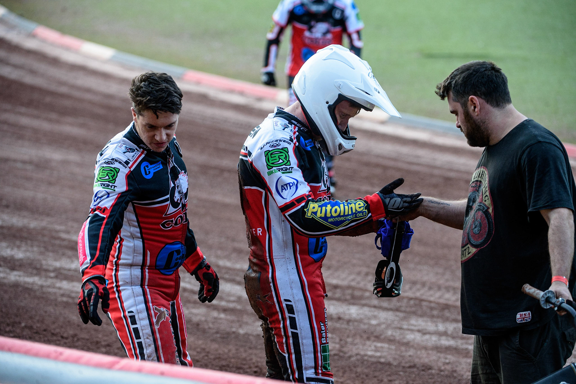 MANCHESTER, UK. JULY 29TH  Paul Bowen  (centre) is helped by his mechanic after his fall, with team captain Ben Woodhull  (left)  during the National Development League match between Belle Vue Colts and Leicester Lion Cubs at the National Speedway Stadium, Manchester on Thursday 29th July 2021. (Credit: Ian Charles | MI News)