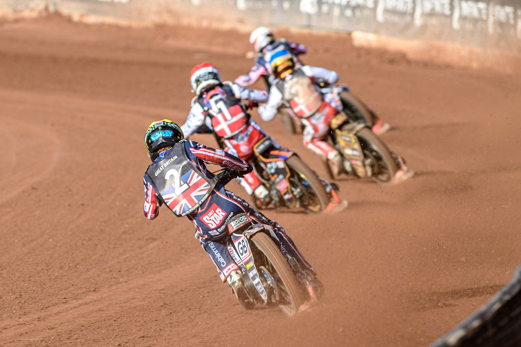 Dan Bewley of Great Britain in Yellow chases Mikkel Michelsen of Denmark in Red Anders Thomsen of Denmark in Blue and Robert Lambert of Great Britain in White during the Monster Energy FIM Speedway of Nation Final at the National Speedway Stadium, Manchester on Saturday 13th July 2024. (Photo: Ian Charles | MI News)