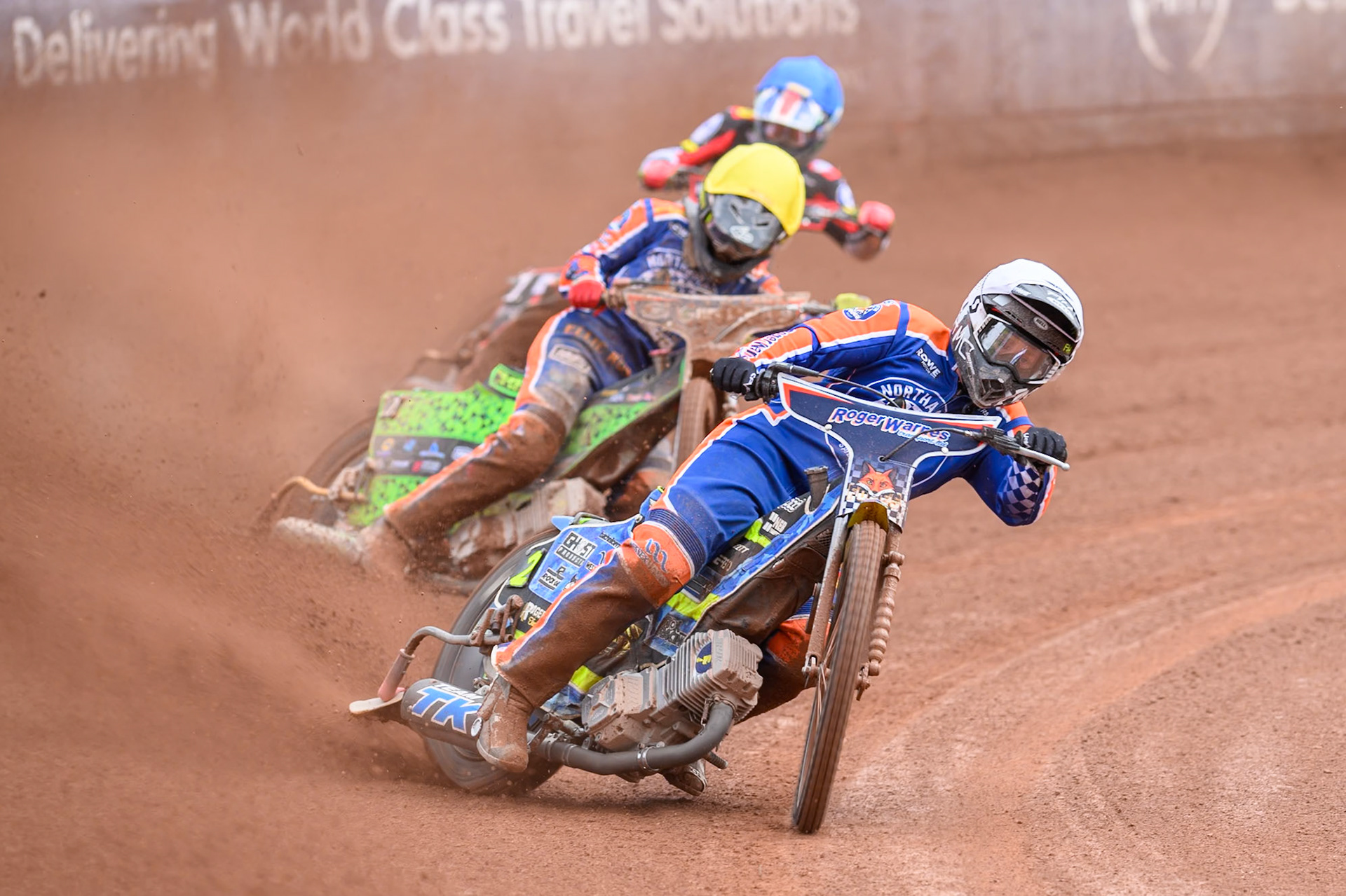Troy Batchelor of Northampton Foxes  in White leading Luke Harrison of Northampton Foxes  in Yellow and Will Cairns of Belle Vue Aces  in Blue during the Rowe Motor Oil Premiership match between Belle Vue Aces and Northampton Foxes at the National Speedway Stadium, Manchester on Monday 4th May 2026. (Photo: Ian Charles | MI News)