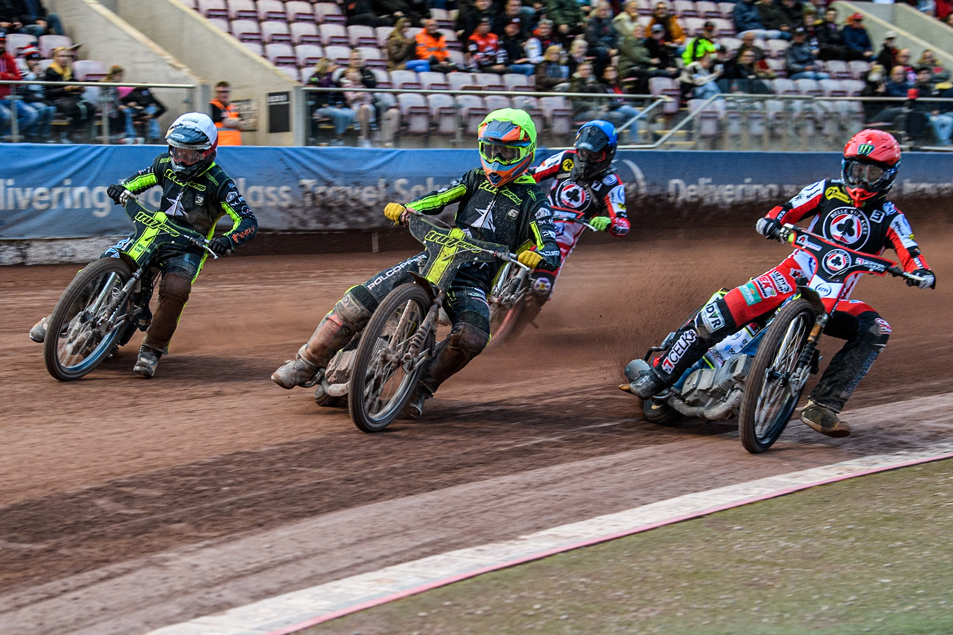 Ipswich Witches' Keynan Rew in Yellow leading Belle Vue Aces' Jaimon Lidsey  in Red and Ipswich Witches' Danny King in White with Belle Vue Aces' Connor Bailey  in Blue behind during the Rowe Motor Oil Premiership match between Belle Vue Aces and Ipswich Witches at the National Speedway Stadium, Manchester on Monday 1st July 2024. (Photo: Ian Charles | MI News)