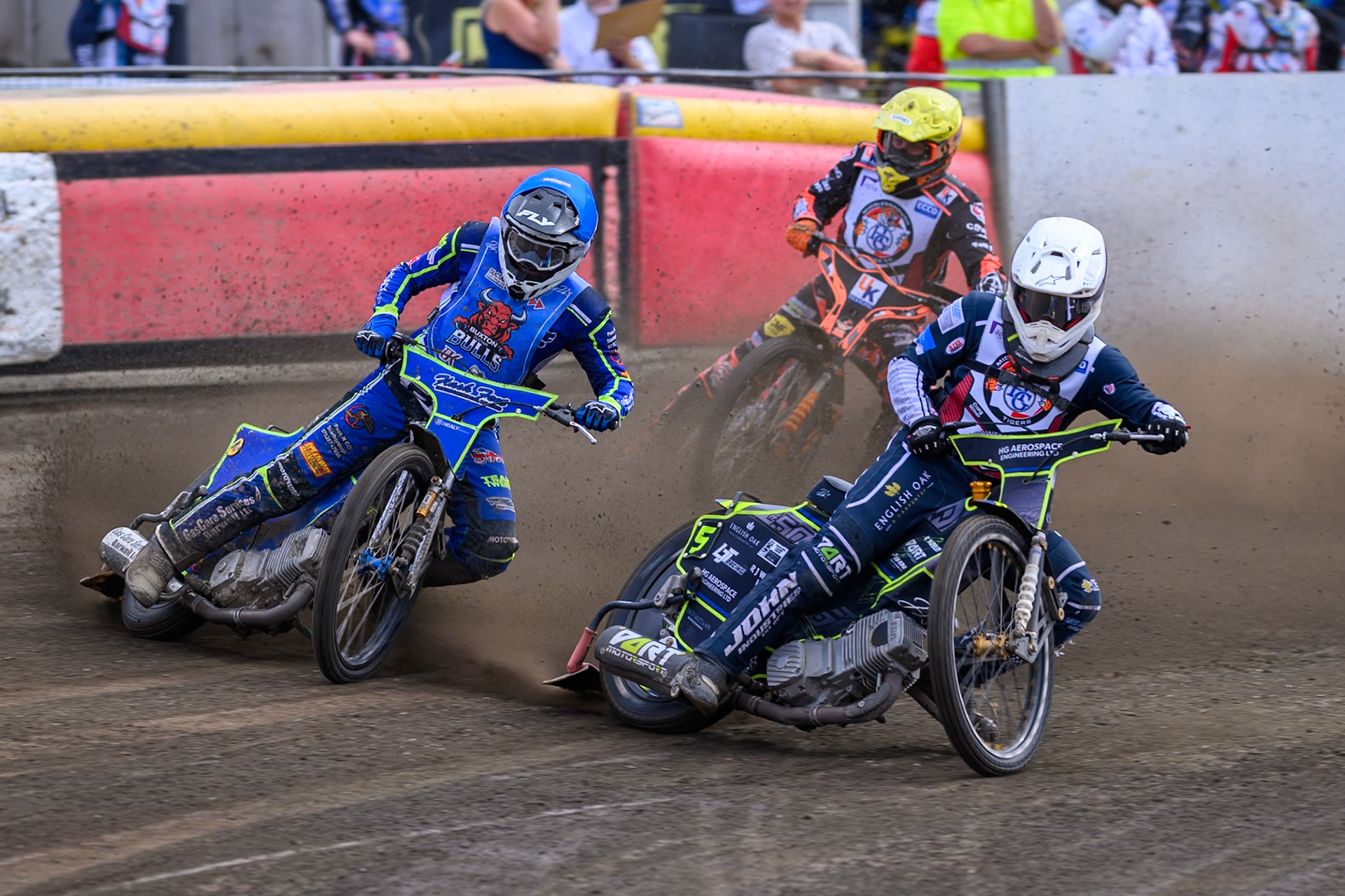 Nathan Ablitt of Middlesborough Tigers on the inside of Arran Butcher of Buxton Bulls in Blue with Alex Spooner of Middlesborough Tigers in Yellow  behind during the WSRA National Development League match  between Buxton Bulls and Middlesborough Tigers at Hi-Edge Speedway, Buxton on Sunday 16th August 2026. (Photo: Ian Charles | MI News)