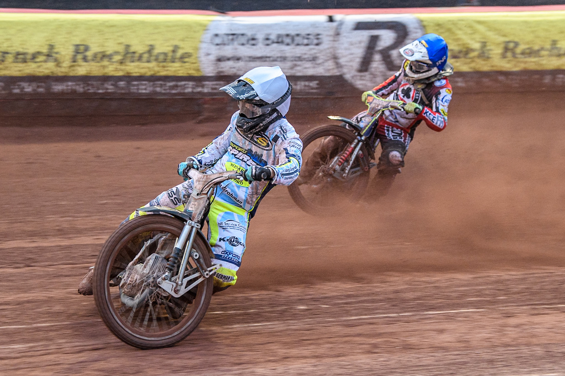 Oxford Spires' Erik Riss  in White leading Belle Vue Aces' guest Jake Mulford  in Blue during the Rowe Motor Oil Premiership match between Belle Vue Aces and Oxford Spires at the National Speedway Stadium, Manchester on Monday 22nd July 2024. (Photo: Ian Charles | MI News)