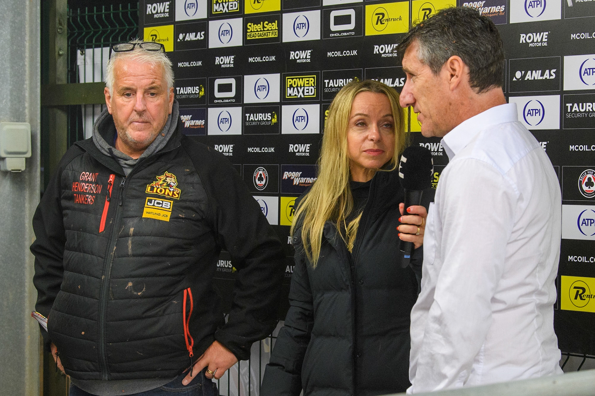 Eurosport presenter Abi Stephens (Centre) interviews Belle Vue Aces' Team Manager Mark Lemon  (Right) with Leicester Lions' Team Manager Stuart Dickson (Left) listening during the Rowe Motor Oil Premiership Grand Final 1st Leg between Belle Vue Aces and Leicester Lions at the National Speedway Stadium, Manchester on Monday 23rd September 2024. (Photo: Ian Charles | MI News)