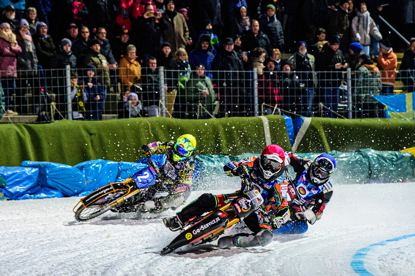 Markus Jell (Red) leads Andrej Divis (Blue) and Maximillian Neidermaier (Yellow) during the German Individual Ice Speedway Championship at Horst-Dohm-Eisstadion, Berlin on Friday 3rd March 2023. (Photo: Ian Charles | MI News)
