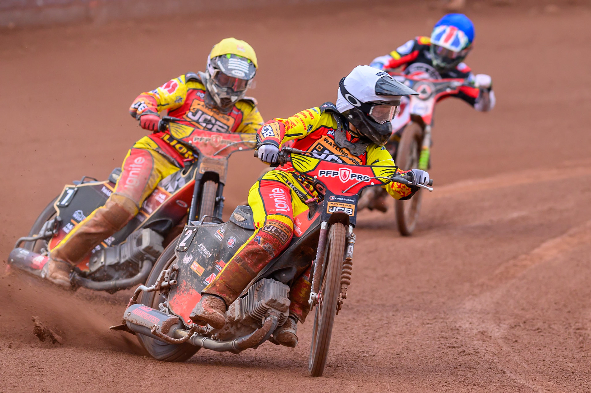 Dan Thompson of Leicester Lions in White leading Joe Thompson of Leicester Lions in Yellow and William Cairns of Belle Vue Aces in Blue during the Rowe Motor Oil Premiership match between Belle Vue Aces and Leicester Lions at the National Speedway Stadium, Manchester on Monday 15th June 2026. (Photo: Ian Charles | MI News)