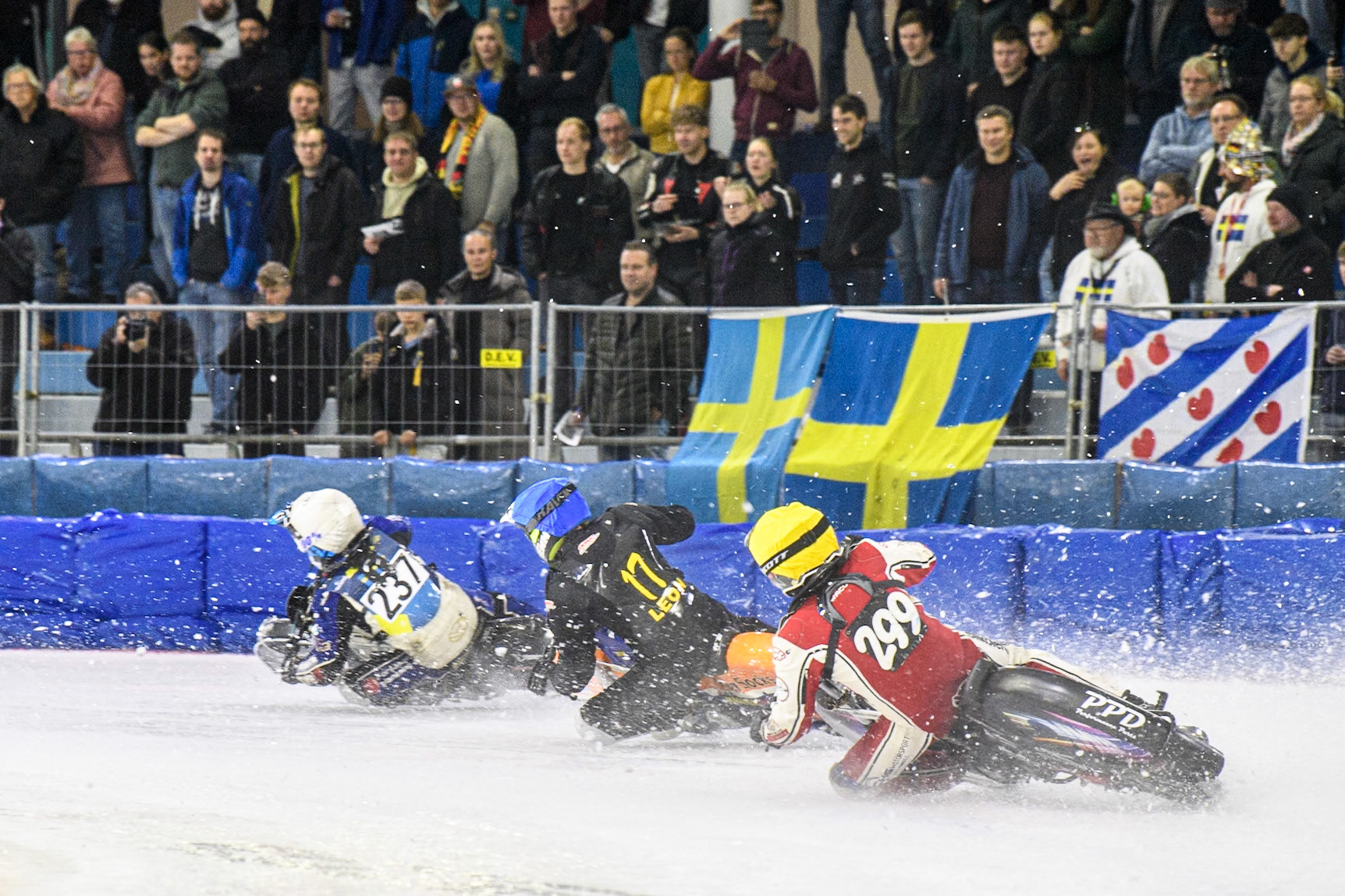 Martin Posch (299) of Austria in Yellow chases Leon Kramer (17) of The Netherlands in Blue and Jimmy Hörnell (237) of Sweden in White during the FIM Ice Speedway Gladiators World Championship, Final 4 at the Ice Stadium, Thialf, Heerenveen on Sunday 6th April 2025. (Photo: Ian Charles | MI News)