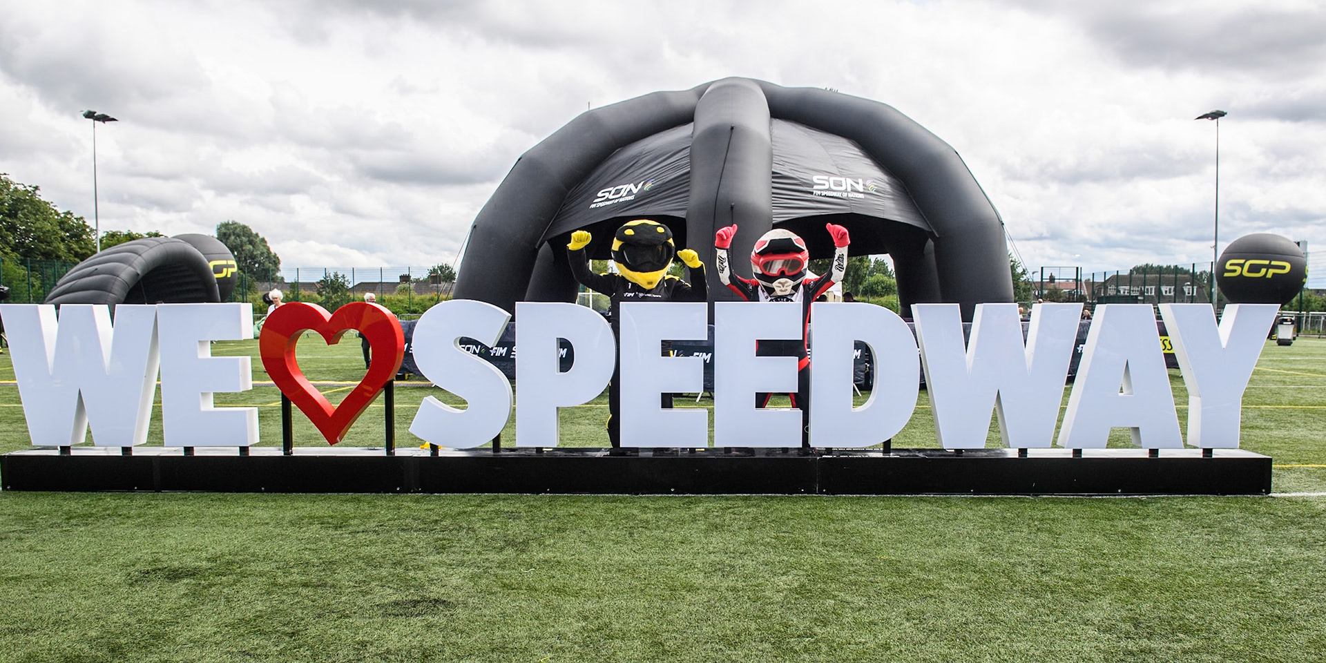 Belle Vue Aces mascot Chase The Ace (Right) and SGP Mascot Speedy behind the welcome sign in the Fanzone during the Monster Energy FIM Speedway of Nations Semi-Final 1 at the National Speedway Stadium, Manchester on Tuesday 9th July 2024. (Photo: Ian Charles | MI News)