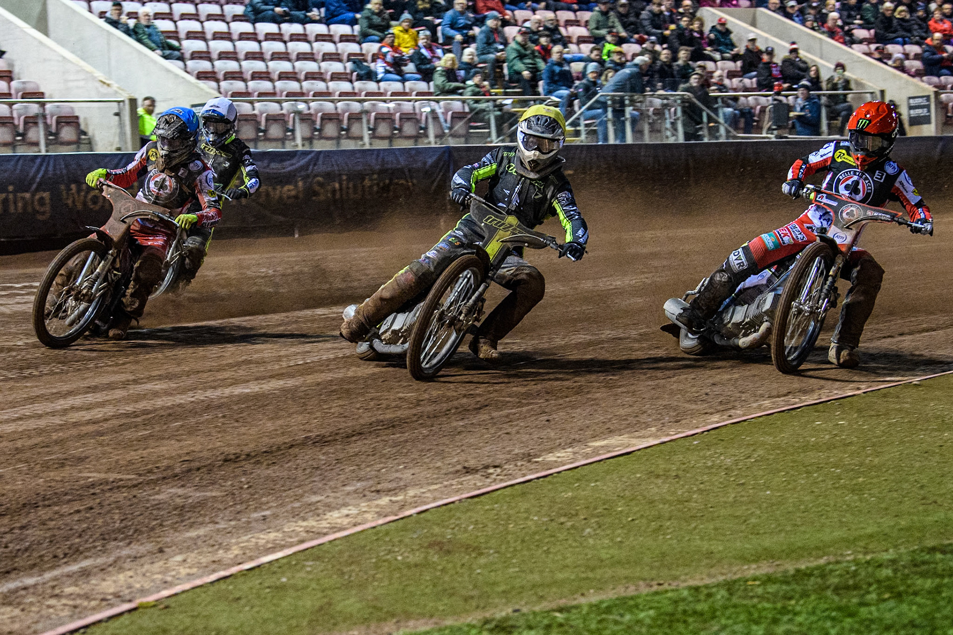 Ipswich Witches' Dan Thompson in Yellow leading \Belle Vue Aces' Jaimon Lidsey in Red and Belle Vue Aces' Connor Bailey in Blue with Ipswich Witches' Adam Ellis in White behind during the Rowe Motor Oil Premiership match between Belle Vue Aces and Ipswich Witches at the National Speedway Stadium, Manchester on Monday 22nd April 2024. (Photo: Ian Charles | MI News)