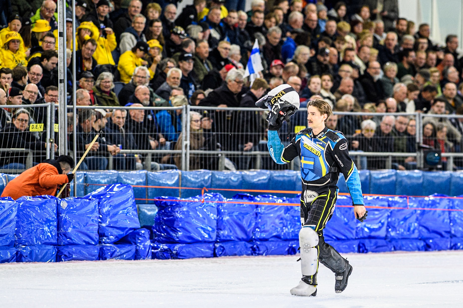 Filip Jäger (719) of Sweden waves to the fans as he walks back to the pits after his fall during the FIM Ice Speedway Gladiators World Championship, Final 4 at the Ice Stadium, Thialf, Heerenveen on Sunday 6th April 2025. (Photo: Ian Charles | MI News)