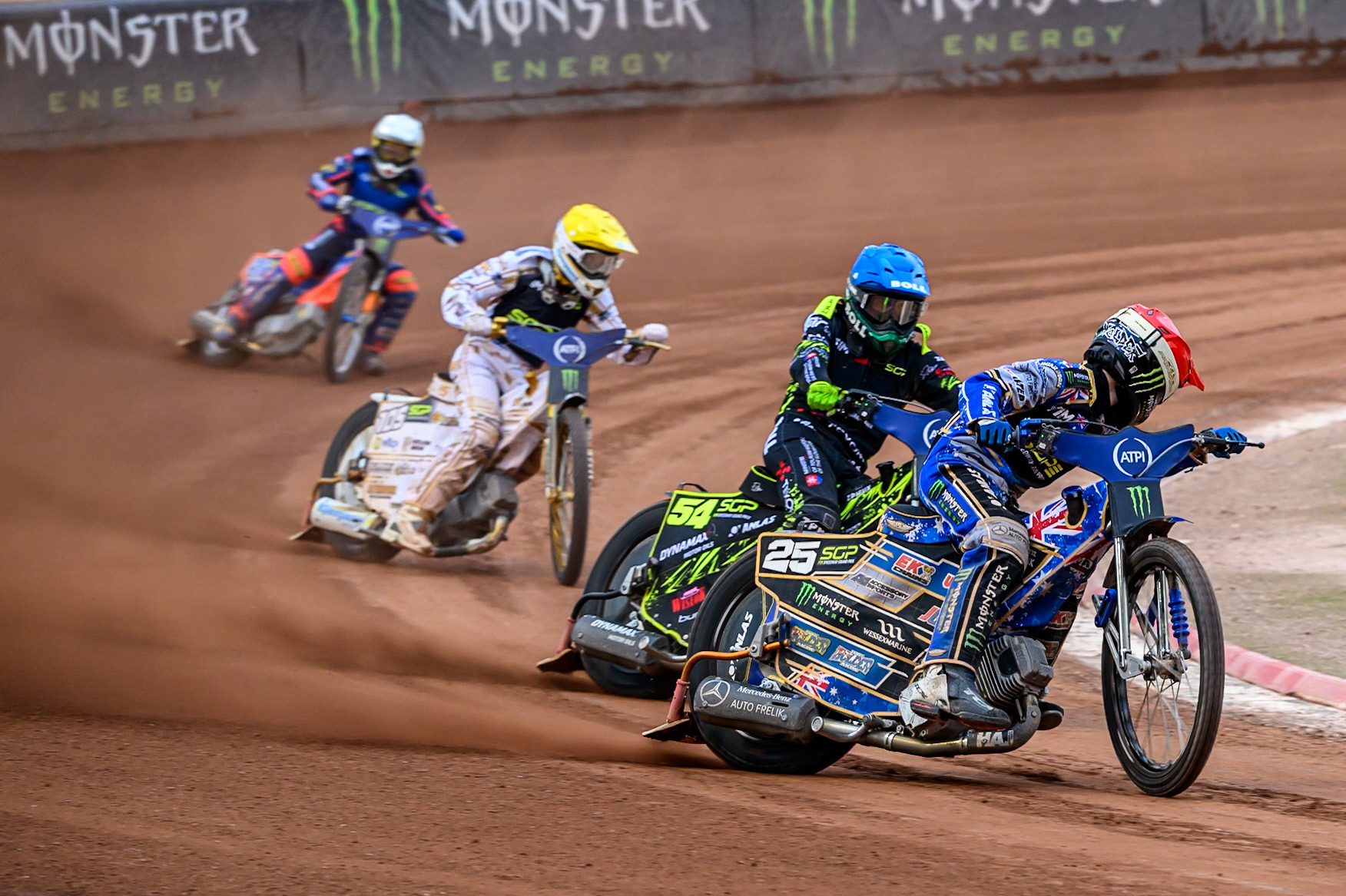 Jack Holder (25) of Australia in Red looks for Martin Vaculik (54) of Slovakia in Blue with Anders Thomsen (105) of Denmark in Yellow and Andzejs Lebedevs (29) of Latvia in White during the ATPI FIM Speedway Grand Prix Round 4 at the National Speedway Stadium, Manchester, on Friday 13th June 2025. (Photo: Ian Charles | MI News)
