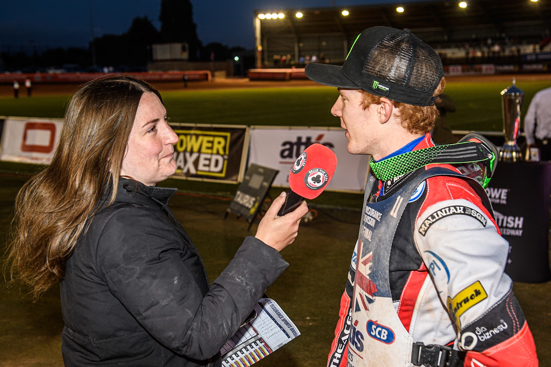 Dan Bewley (Right) is interviewed by meeting presenter Hayley Bromley during the Attis Insurance Sports Division British Speedway Championship Final at the National Speedway Stadium, Manchester on Saturday 8th June 2024. (Photo: Ian Charles | MI News)