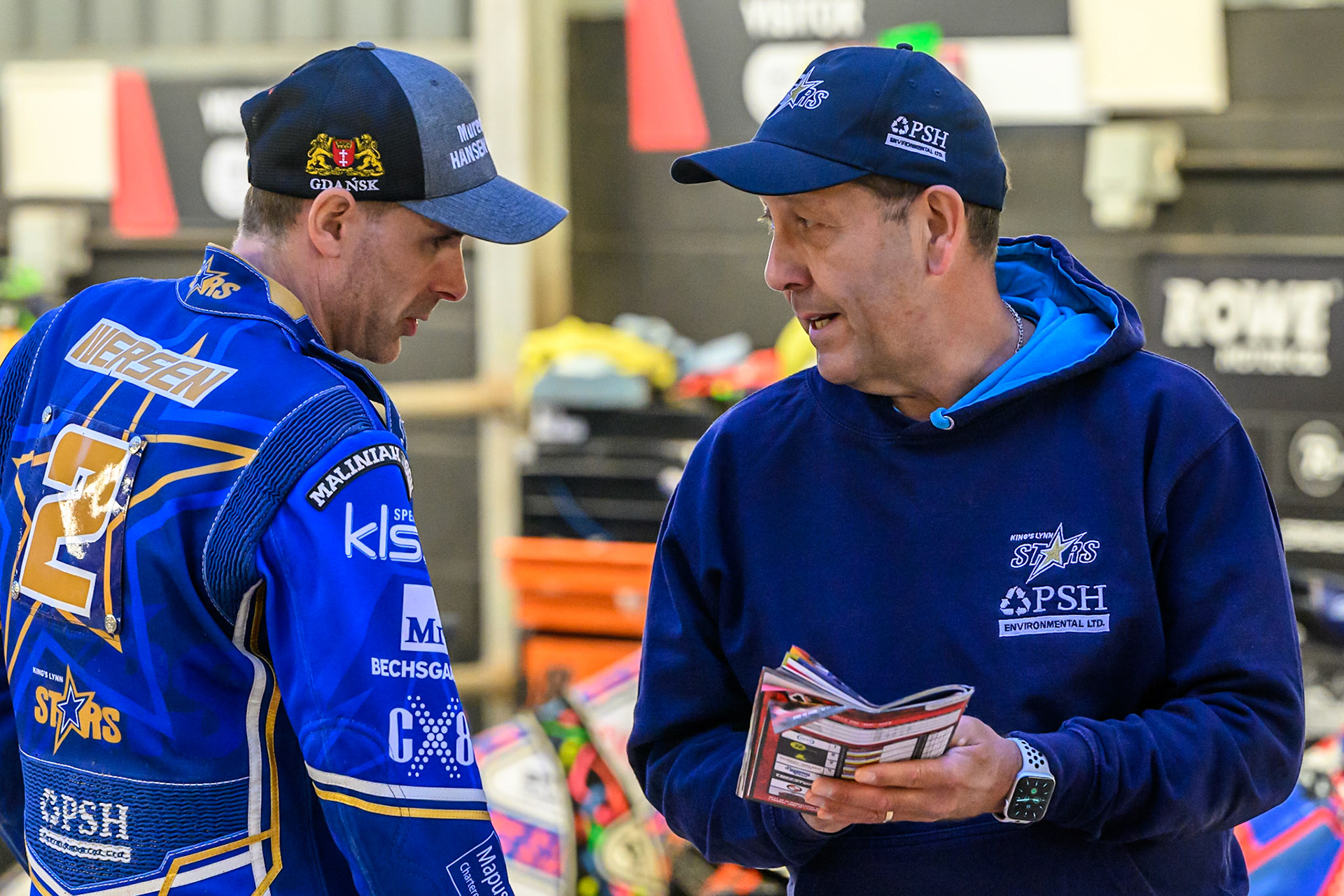 Kings Lynn Stars' Niels-Kristian Iversen (Left) chats with Kings Lynn Stars' Team Manager Rob Lyon during the Rowe Motor Oil Premiership match between Belle Vue Aces and King's Lynn Stars at the National Speedway Stadium, Manchester on Monday 23rd June 2025. (Photo: Ian Charles | MI News)