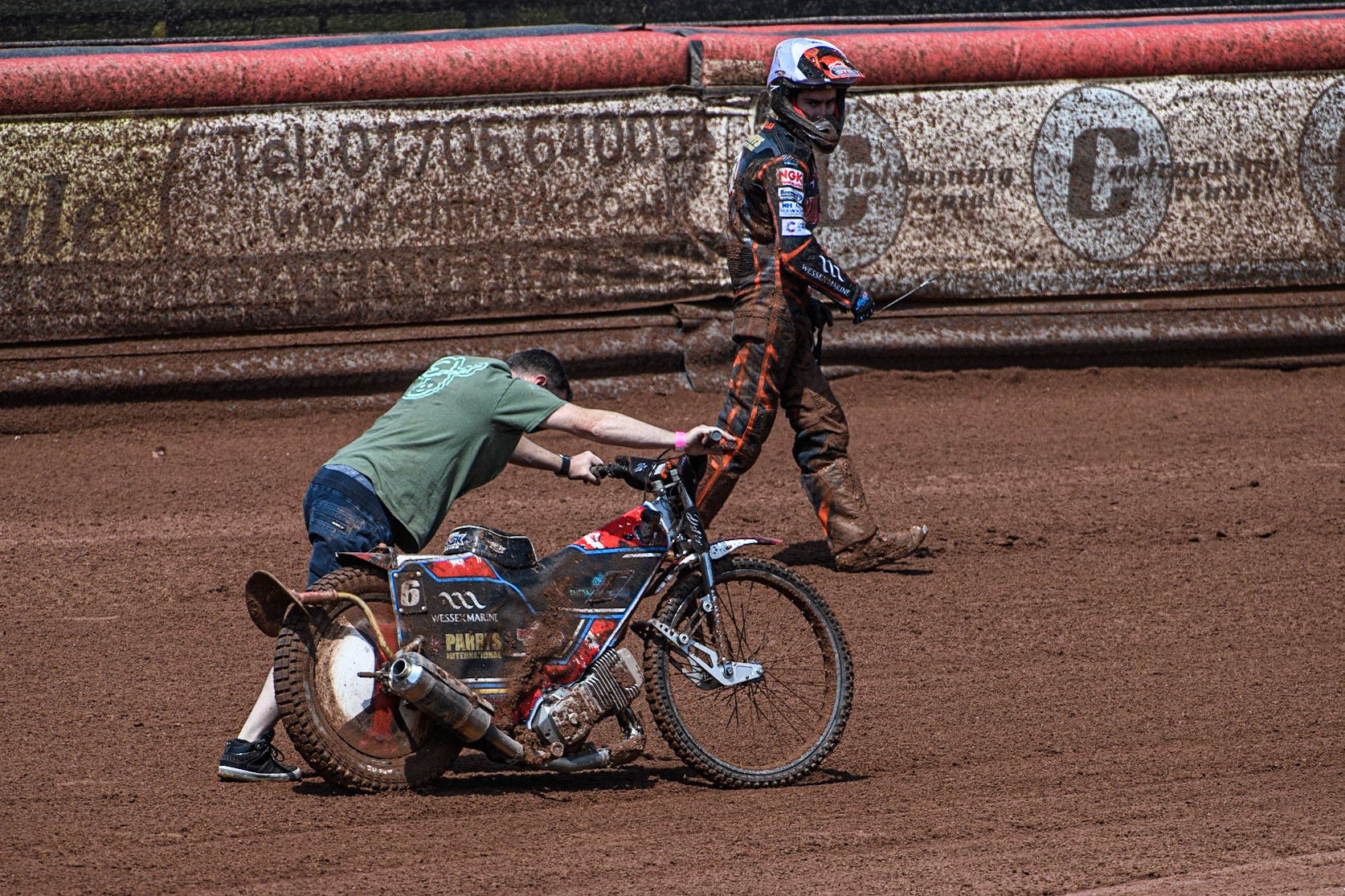 A mechanic pushes Zach Cook’s bike back to the pits with Zach Cook ahead of him during the Sports Insure Premiership match between Belle Vue Aces and Wolverhampton Wolves at the National Speedway Stadium, Manchester on Monday 29th May 2023. (Photo: Ian Charles | MI News)