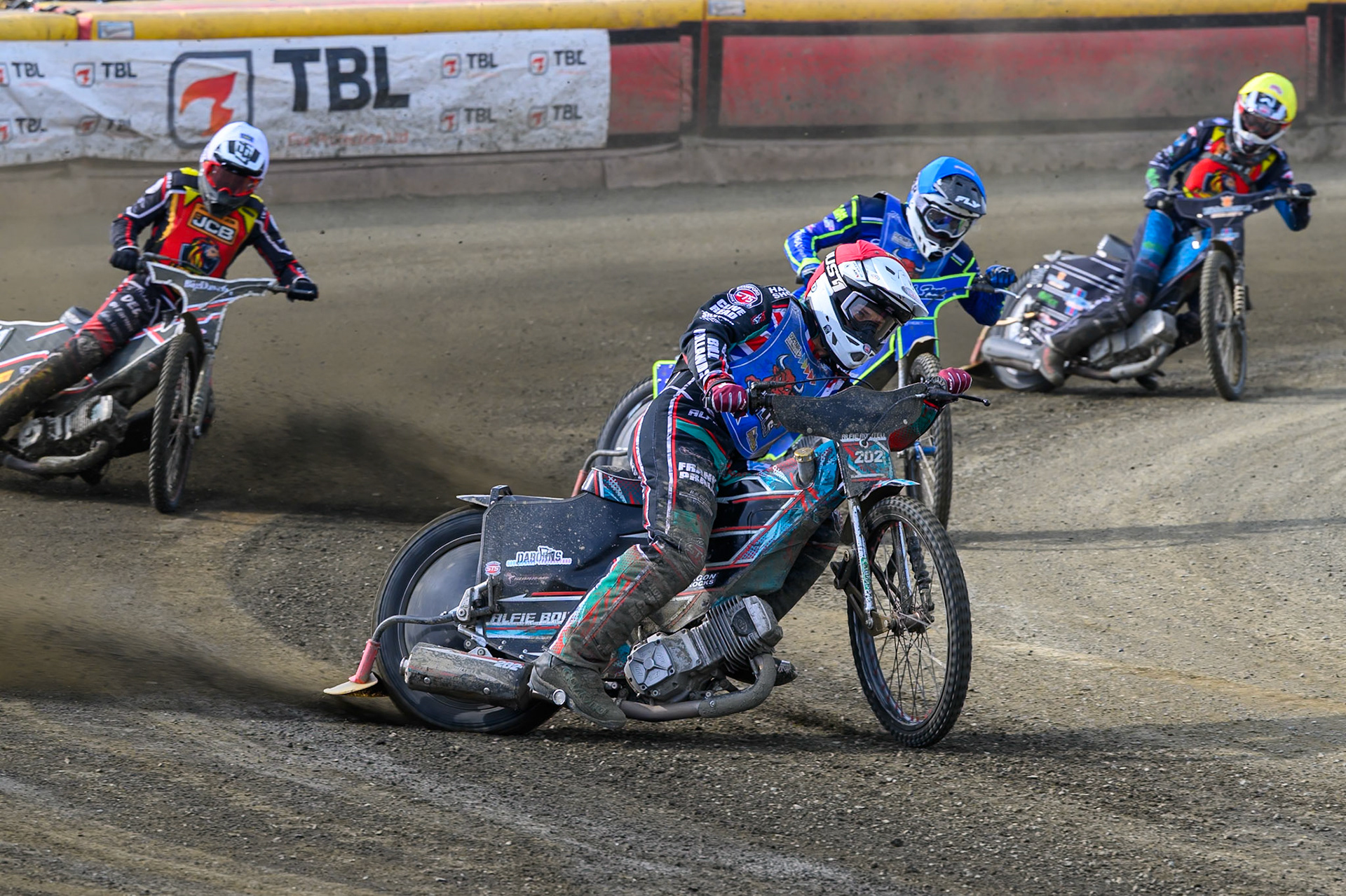 Alfie Bowtell of Buxton Bulls  in Red and Arran Butcher of Buxton Bulls  in Blue score maximum points in Heat 13 ahead of Ben Morley of Leicester Lion Cubs  in White and Freddy Hodder of Leicester Lion Cubs  in Yellow during the Challenge match between Buxton Bulls and Leicester Lion Cubs at Hi-Edge Speedway, Buxton on Sunday 26th April 2026. (Photo: Ian Charles | MI News)
