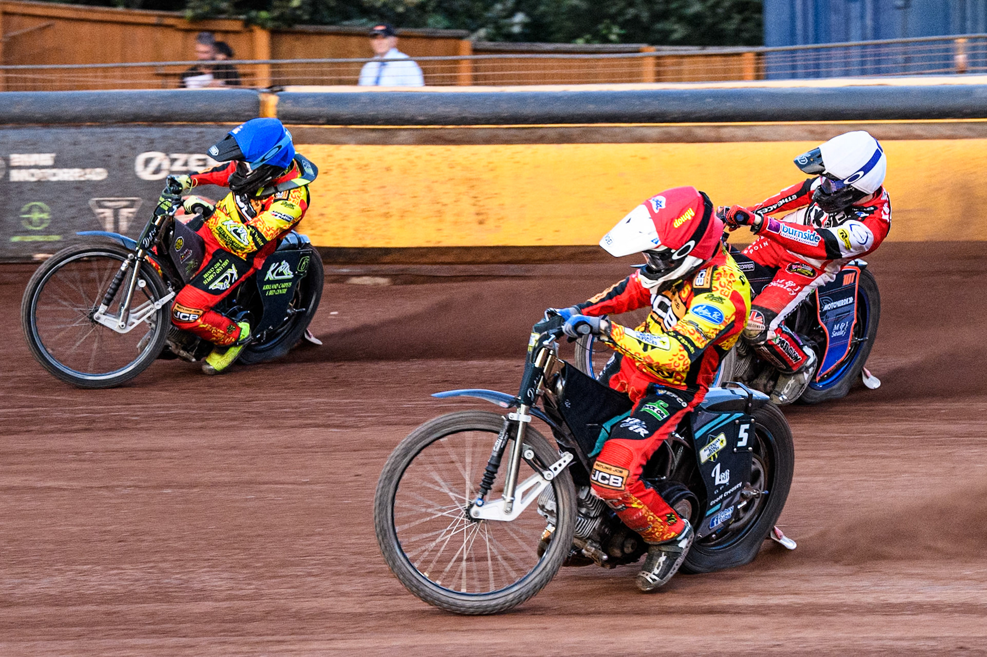 Leicester Lions' Ryan Douglas in Red rides inside Leicester Lions' Craig Cook in Blue with Belle Vue Aces' Brady Kurtz in White behind during the Rowe Motor Oil Premiership match between Leicester Lions and Belle Vue Aces at the Pidcock Motorcycles Arena, Leicester on Thursday 25th July 2024. (Photo: Ian Charles | MI News)