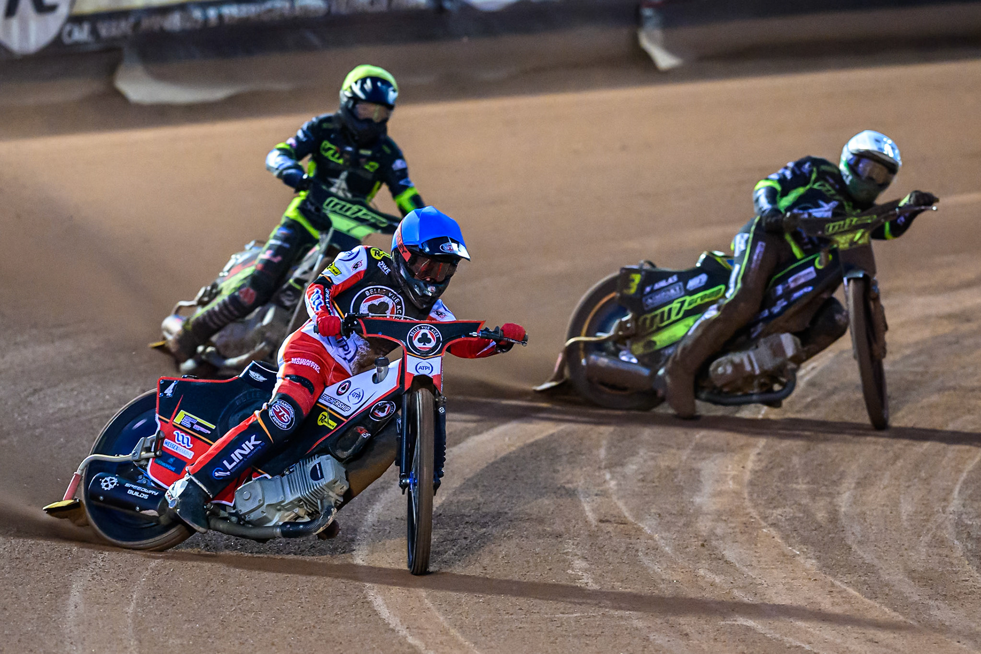 Zach Cook of Belle Vue Aces  in Blue leading Jason Doyle of Ipswich Witches  in White and Dan Thompson of Ipswich Witches  in Yellow during the Rowe Motor Oil Premiership Play Off Semi Final 1 (1st Leg)  between Belle Vue Aces and Ipswich Witches at the National Speedway Stadium, Manchester on Monday 8th September 2025. (Photo: Ian Charles | MI News)