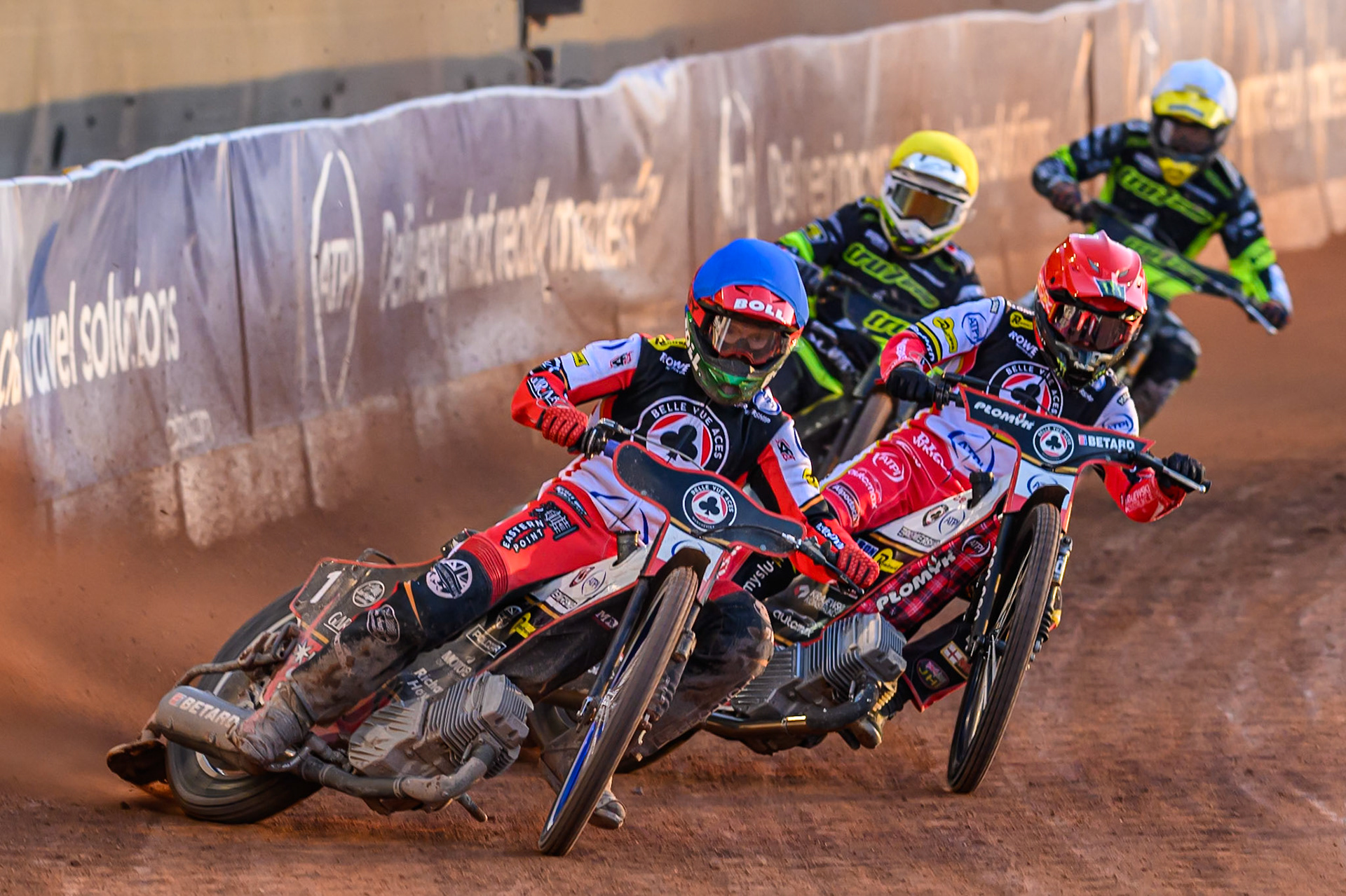 Brady Kurtz of Belle Vue Aces  in Blue and Dan Bewley of Belle Vue Aces  in Red leading Tom Brennan of Ipswich Witches  in Yellow and Adam Ellis of Ipswich Witches  in White during the Rowe Motor Oil Premiership match between Belle Vue Aces and Ipswich Witches at the National Speedway Stadium, Manchester on Monday 4th August 2025. (Photo: Ian Charles | MI News)