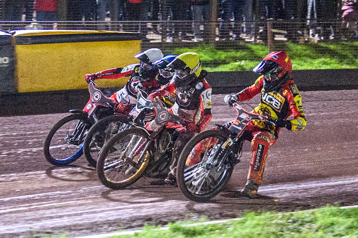 Leicester Lions' Sam Masters in Red rides inside Belle Vue Aces' Norick Blodorn in Yellow, Leicester Lions' Luke Becker in Blue and Belle Vue Aces' Brady Kurtz in White during the Rowe Motor Oil Premiership Grand Final 2nd Leg between Leicester Lions and Belle Vue Aces at the Pidcock Motorcycles Arena, Leicester on Thursday 26th September 2024. (Photo: Ian Charles | MI News)