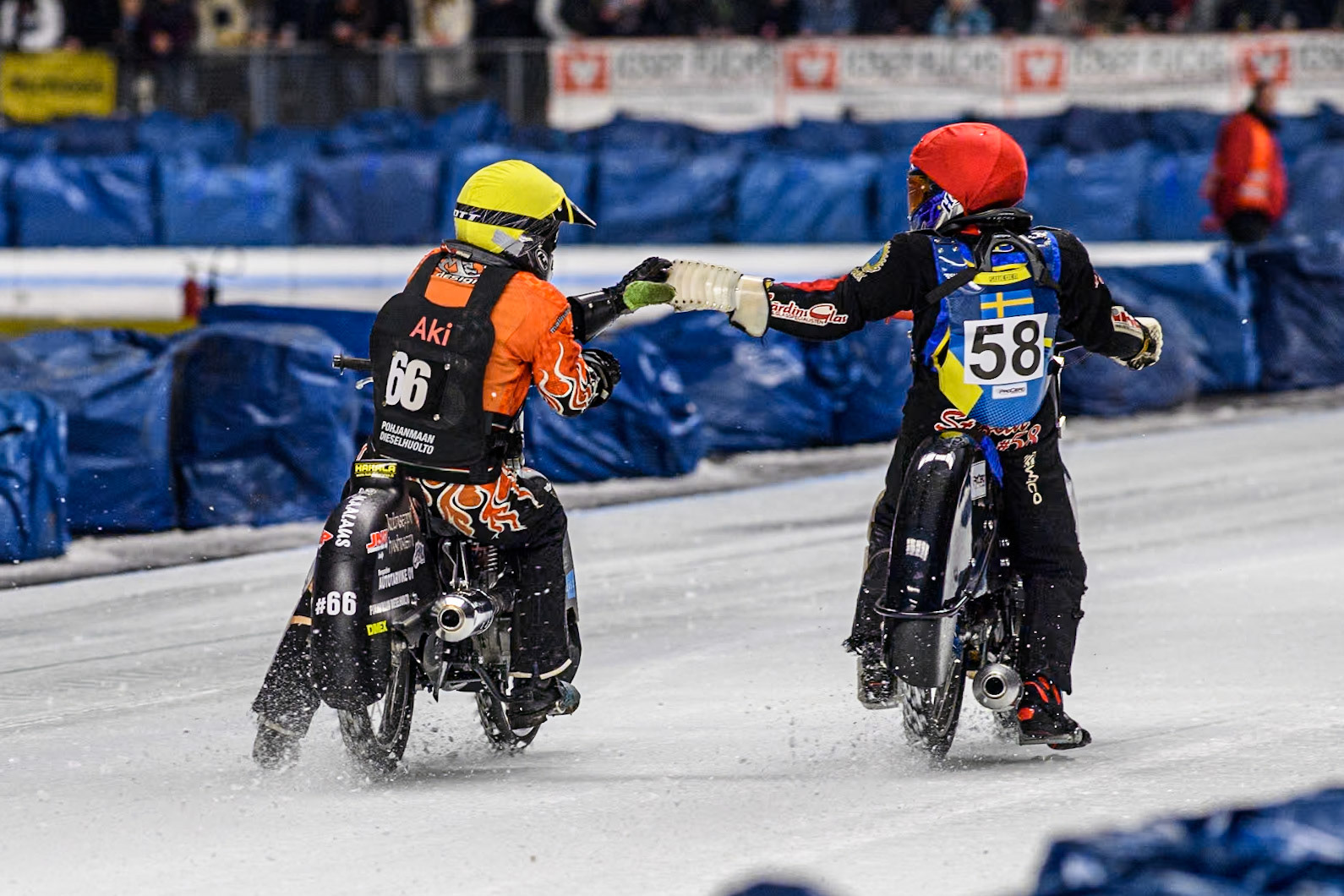 Finland's Aki Ala-Riihimäki (66) congratulates Sweden's Stefan Svensson (58) on his win during the FIM Ice Speedway Gladiators World Championship Final 1 at the Max-Aicher-Arena, Inzell on Saturday 23 March 2024. (Photo: Ian Charles | MI News)