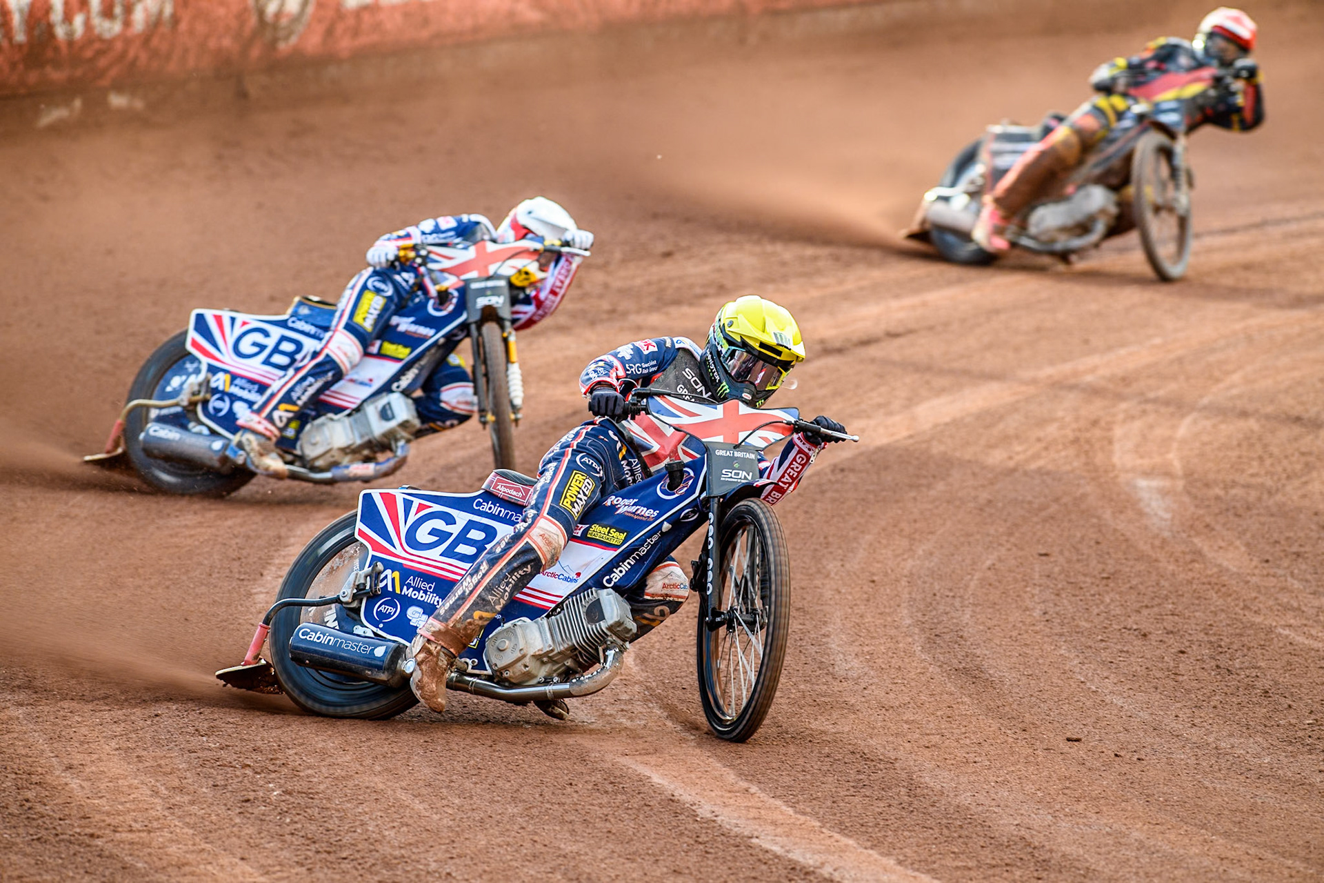 Dan Bewley of Great Britain in Yellow leading team mate Robert Lambert and Kai Huckenbeck of Germany in Red during the Monster Energy FIM Speedway of Nation Final at the National Speedway Stadium, Manchester on Saturday 13th July 2024. (Photo: Ian Charles | MI News)