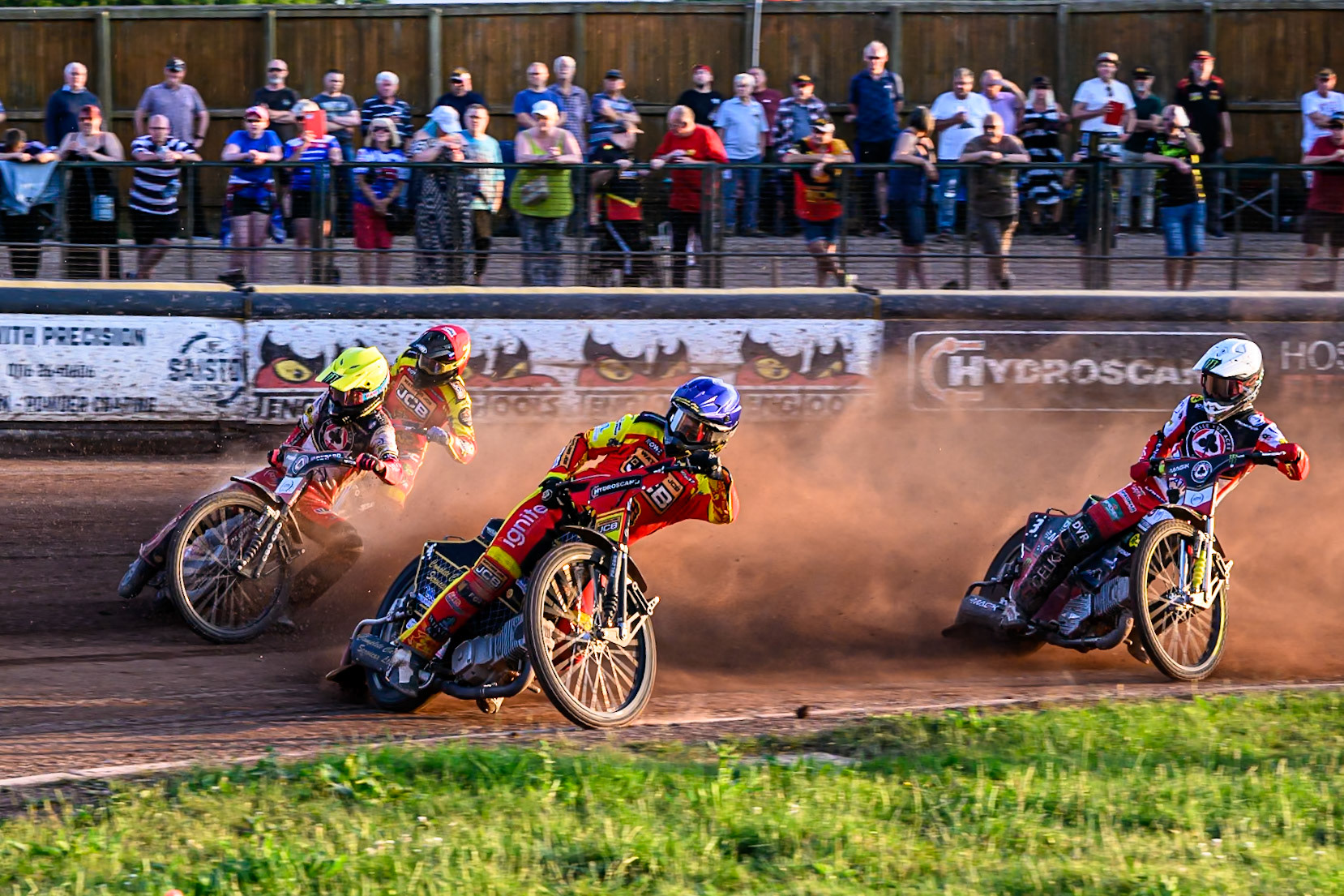 Belle Vue Aces' Dan Bewley in Yellow rides outside Leicester Lions' Kyle Howarth in Blue with Belle Vue Aces' Jaimon Lidsey in White and Leicester Lions' Ryan Douglas in Red behind during the Rowe Motor Oil Premiership match between Leicester Lions and Belle Vue Aces at the Hydroscand Arena, Leicester on Thursday 19th June 2025. (Photo: Ian Charles | MI News)