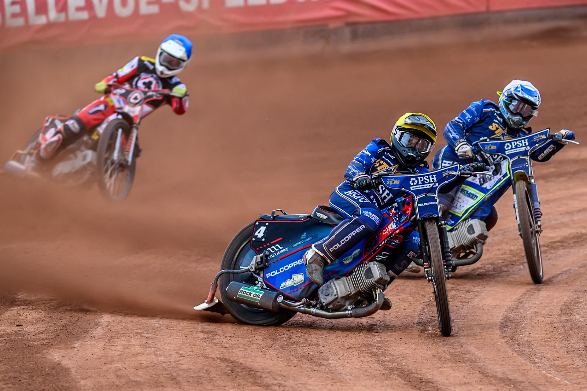 Kings Lynn Stars' Ben Cook in Yellow leading Kings Lynn Stars' Chris Harris in White and Belle Vue Aces' Jake Mulford in Blue during the Rowe Motor Oil Premiership match between Belle Vue Aces and King's Lynn Stars at the National Speedway Stadium, Manchester on Monday 23rd June 2025. (Photo: Ian Charles | MI News)