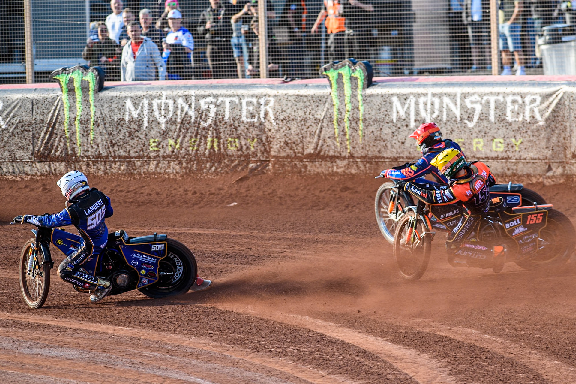 Robert Lambert (505) of Great Britain in White rides inside Mikkel Michelsen (155) of Denmark in Yellow and Andzejs Lebedevs (29) of Latvia in Red during the ATPI FIM Speedway Grand Prix Round 5 at the National Speedway Stadium, Manchester, on Saturday 14th June 2025. (Photo: Ian Charles | MI News)