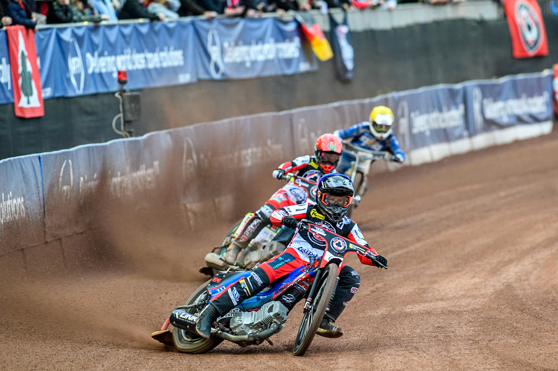 Belle Vue Aces' Ben Cook in Blue in Blue leading Belle Vue Aces' Jaimon Lidsey in Red and King Lynn Stars' Guest Richard Lawson in Yellow during the Rowe Motor Oil Premiership match between Belle Vue Aces and King's Lynn Stars at the National Speedway Stadium, Manchester on Monday 20th May 2024. (Photo: Ian Charles | MI News)