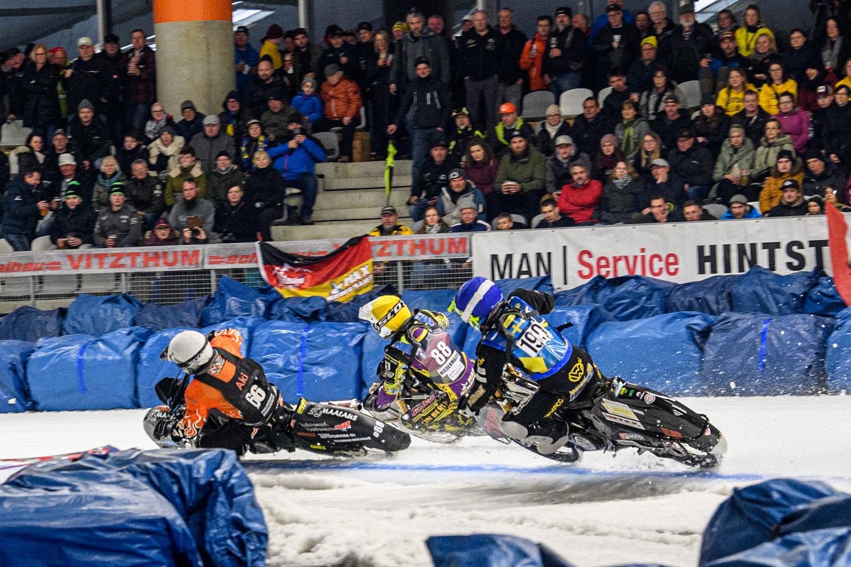 Sweden's Martin Haarahiltunen (199)  chases Germany's Max Niedermaier (88) (Yellow) and Finland's Aki Ala-Riihimäki (66) (White) during the FIM Ice Speedway Gladiators World Championship Final 1 at the Max-Aicher-Arena, Inzell on Saturday 23 March 2024. (Photo: Ian Charles | MI News)