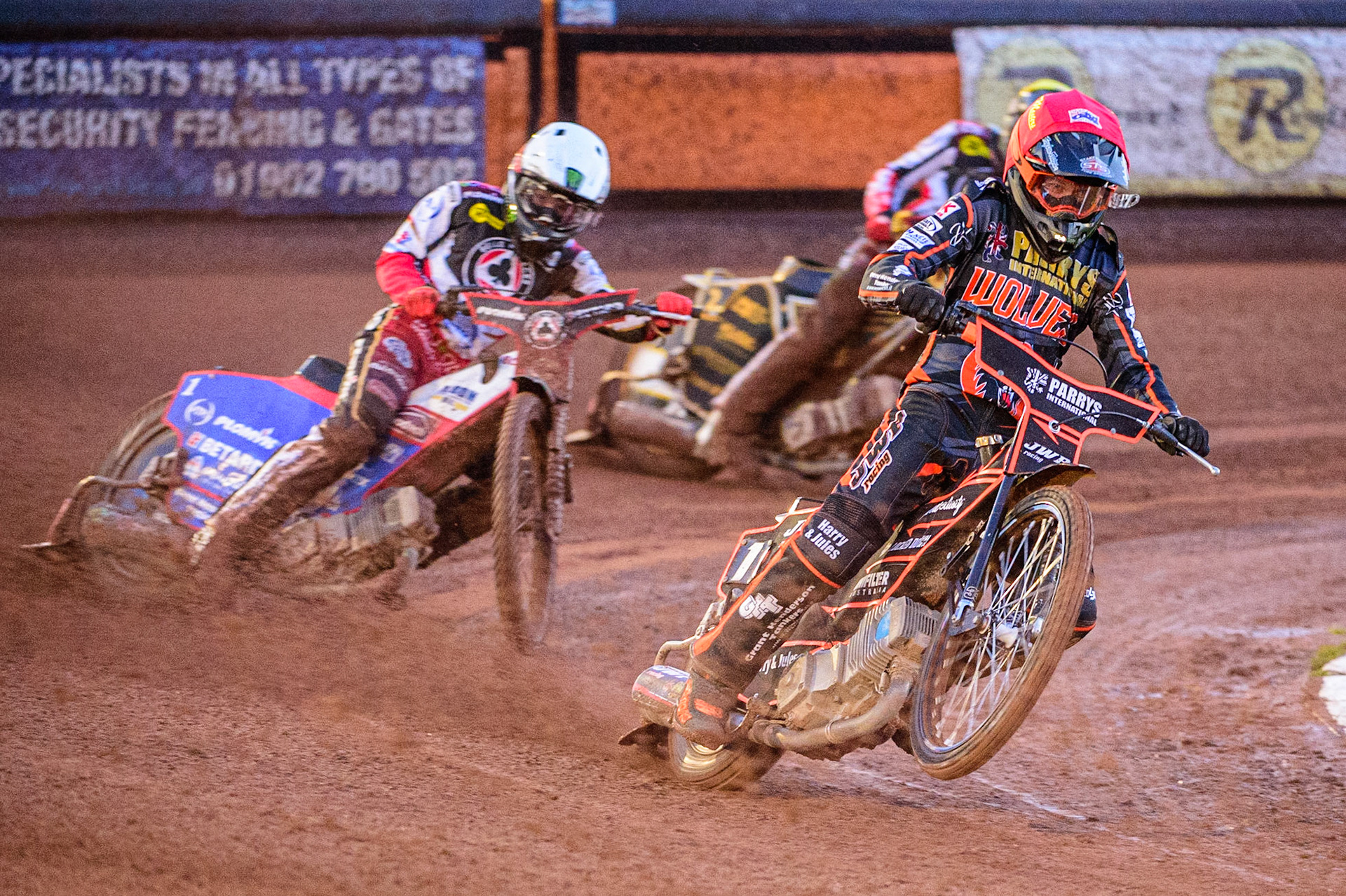 Sam Masters  (Red) picks up some drive ahead of Dan Bewley  (White) and Norick Blodorn  (Yellow) during the SGB Premiership Knock Out Cup Quarter Final 1st Leg between Wolverhampton Wolves and Belle Vue Aces at Monmore Green Stadium, Wolverhampton on Monday 10th April 2023. (Photo: Ian Charles | MI News)