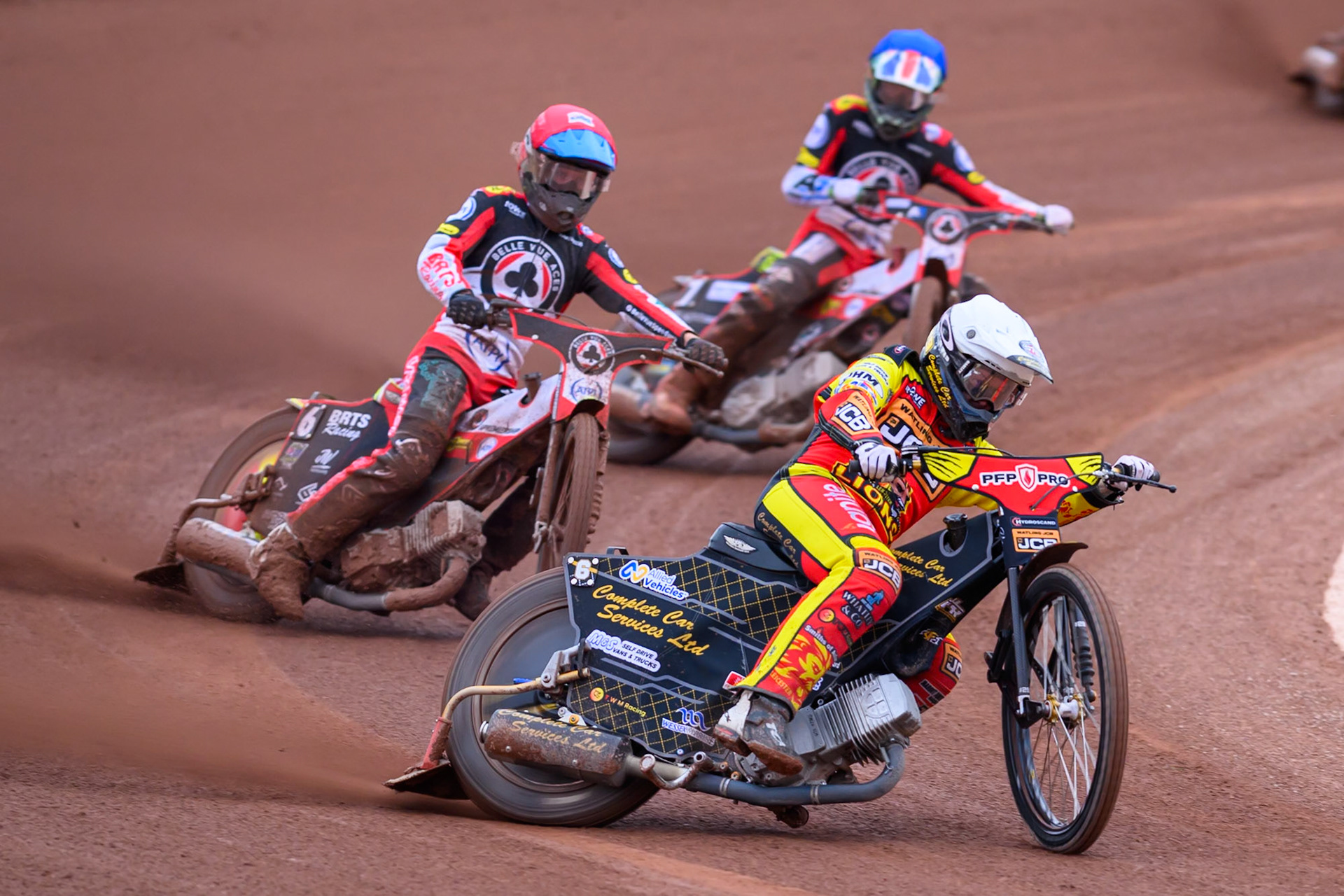 Kyle Howarth of Leicester Lions in White leading Tate Zischke of Belle Vue Aces in Red and William Cairns of Belle Vue Aces in Blue during the Rowe Motor Oil Premiership match between Belle Vue Aces and Leicester Lions at the National Speedway Stadium, Manchester on Monday 15th June 2026. (Photo: Ian Charles | MI News)