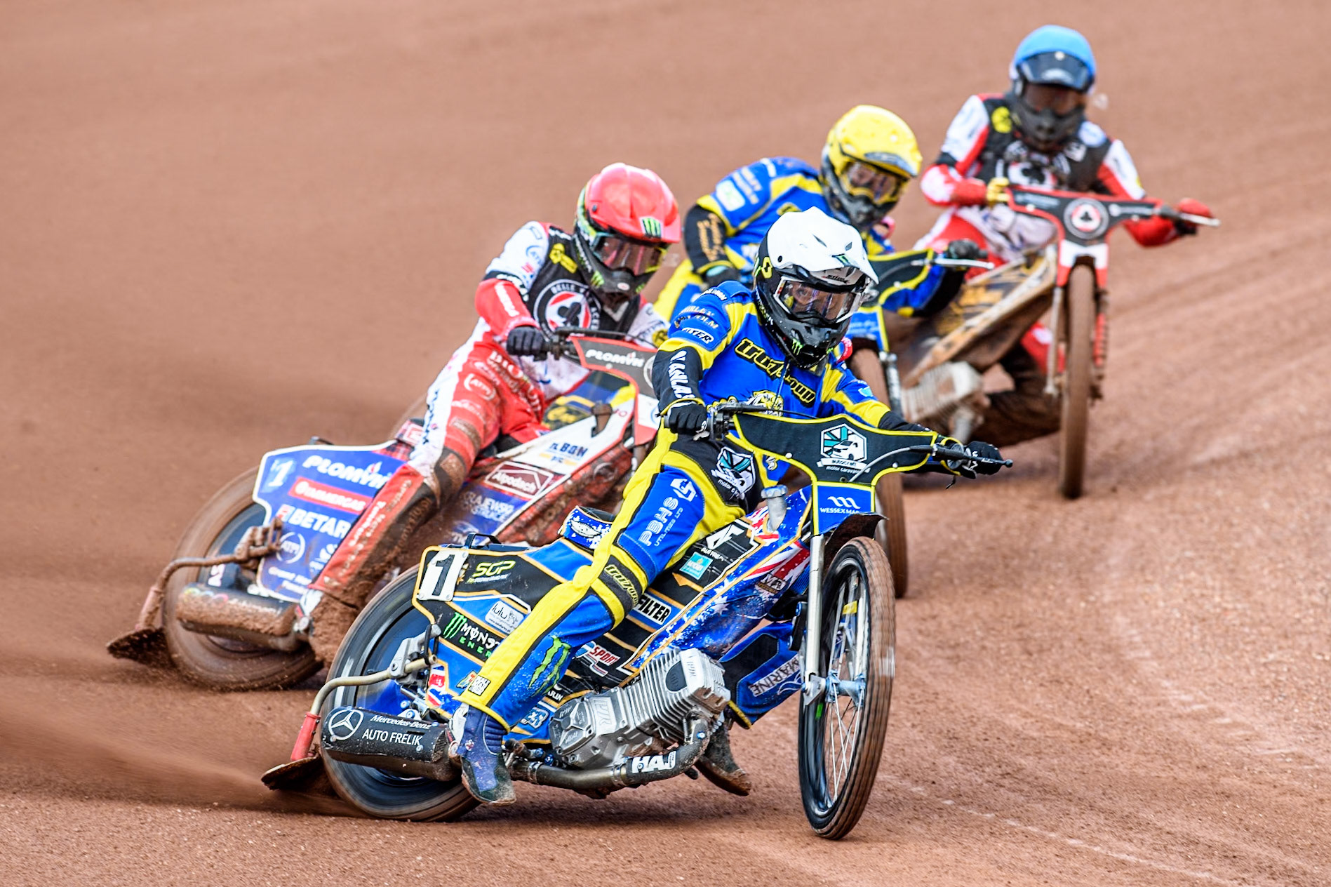 Sheffield Tigers' Jack Holder  leading Belle Vue Aces' Dan Bewley   in Red, Sheffield Tigers' Kyle Howarth  in Yellow and Belle Vue Aces' Norick Blödorn  in Blue during the Rowe Motor Oil Premiership match between Belle Vue Aces and Sheffield Tigers at the National Speedway Stadium, Manchester on Monday 26th August 2024. (Photo: Ian Charles | MI News)