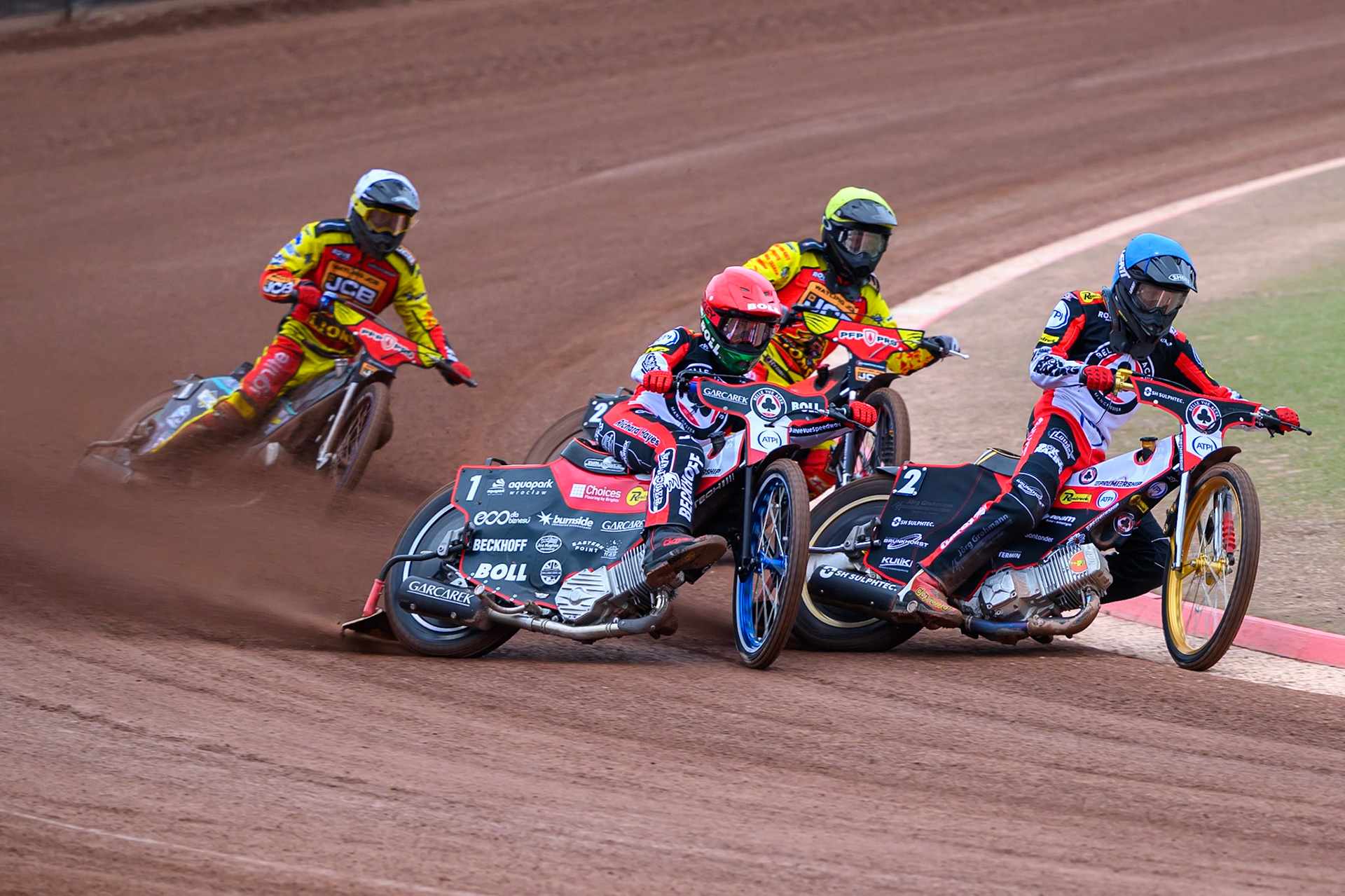 Brady Kurtz in Red and team mate Norick Blödorn of Belle Vue Aces in Blue leading Dan Thompson of Leicester Lions in Yellow and Ryan Douglas of Leicester Lions in White during the Rowe Motor Oil Premiership match between Belle Vue Aces and Leicester Lions at the National Speedway Stadium, Manchester on Monday 15th June 2026. (Photo: Ian Charles | MI News)