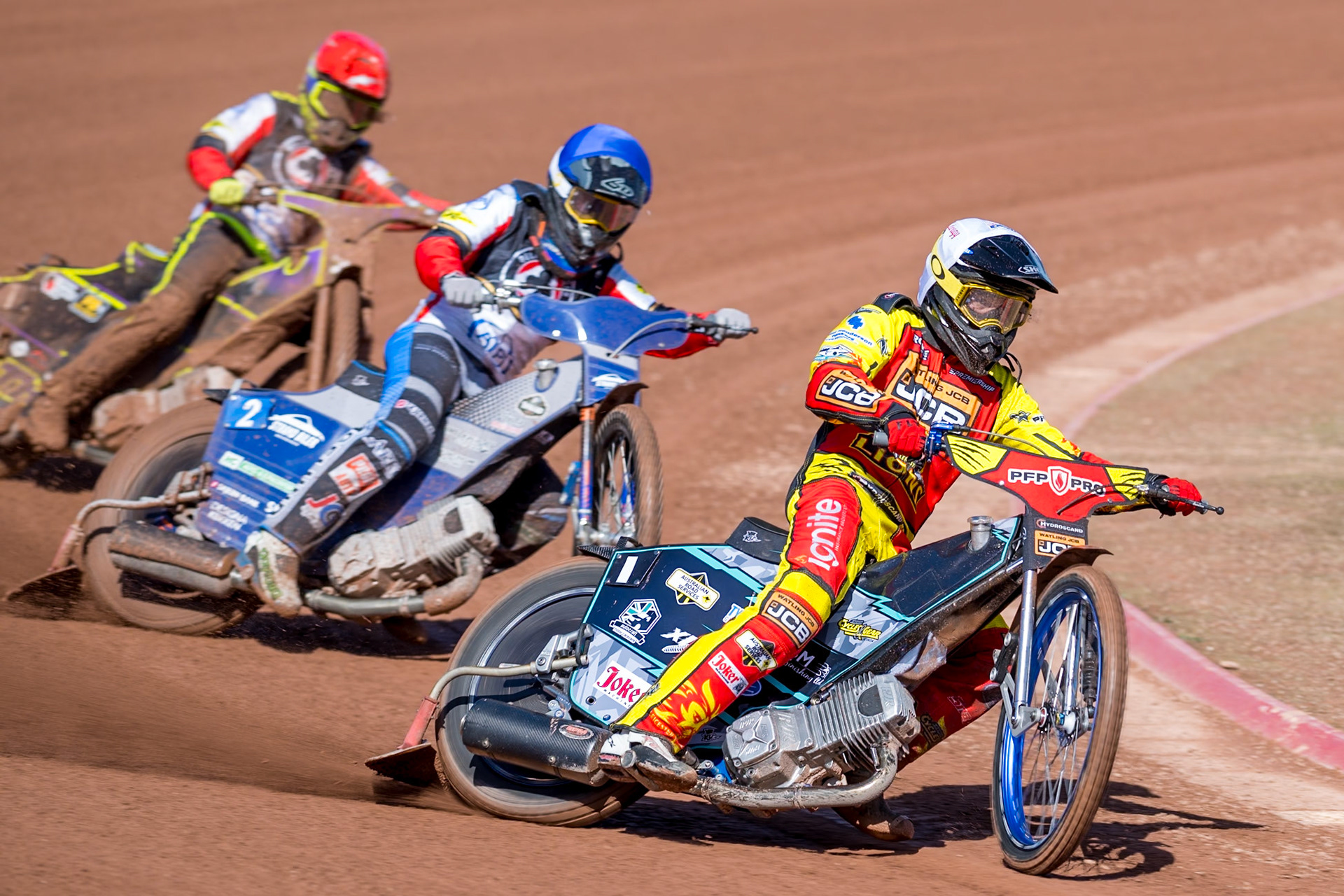 Ryan Douglas of Leicester Lions in White leading Jonas Jeppesen Guest Rider for Belle Vue Aces in Blue and Tom Brennan Guest Rider for Belle Vue Aces  in Red during the Knockout Cup Northern Section match between Belle Vue Aces and Leicester Lions at the National Speedway Stadium, Manchester on Monday 6th April 2026. (Photo: Ian Charles | MI News)