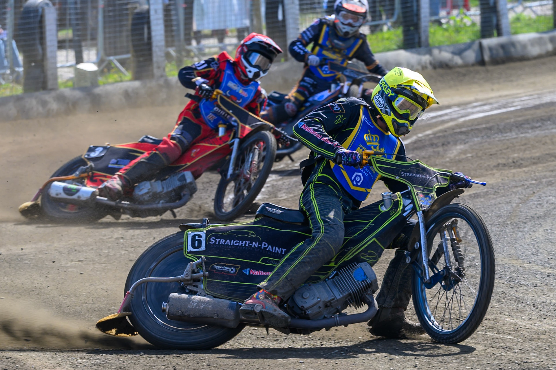 Ben Whalley of Edinburgh Monarchs Academy in Yellow leading Luke Harris of Buxton Bulls in Red and Ryan Ingram, Guest Rider for Edinburgh Monarchs Academy in White during the WSRA National Development League match between Buxton Bulls and Edinburgh Monarchs Academy at Hi-Edge Speedway, Buxton on Sunday 14th June 2026. (Photo: Ian Charles | MI News)