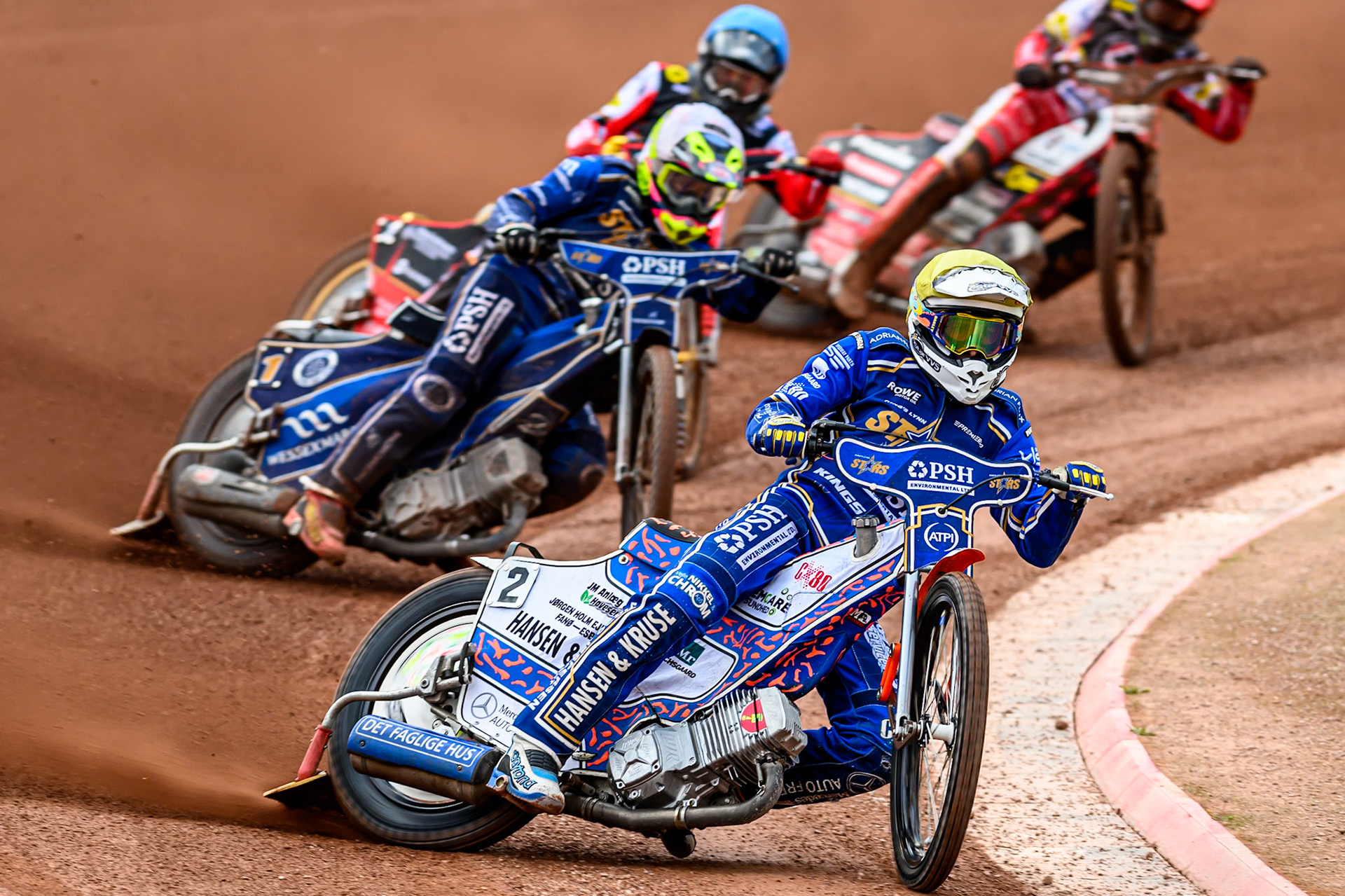 Kings Lynn Stars' Niels-Kristian Iversen in Yellow leading Kings Lynn Stars' Richard Lawson in White and Belle Vue Aces' Norick Blödorn in Blue during the Rowe Motor Oil Premiership match between Belle Vue Aces and King's Lynn Stars at the National Speedway Stadium, Manchester on Monday 23rd June 2025. (Photo: Ian Charles | MI News)