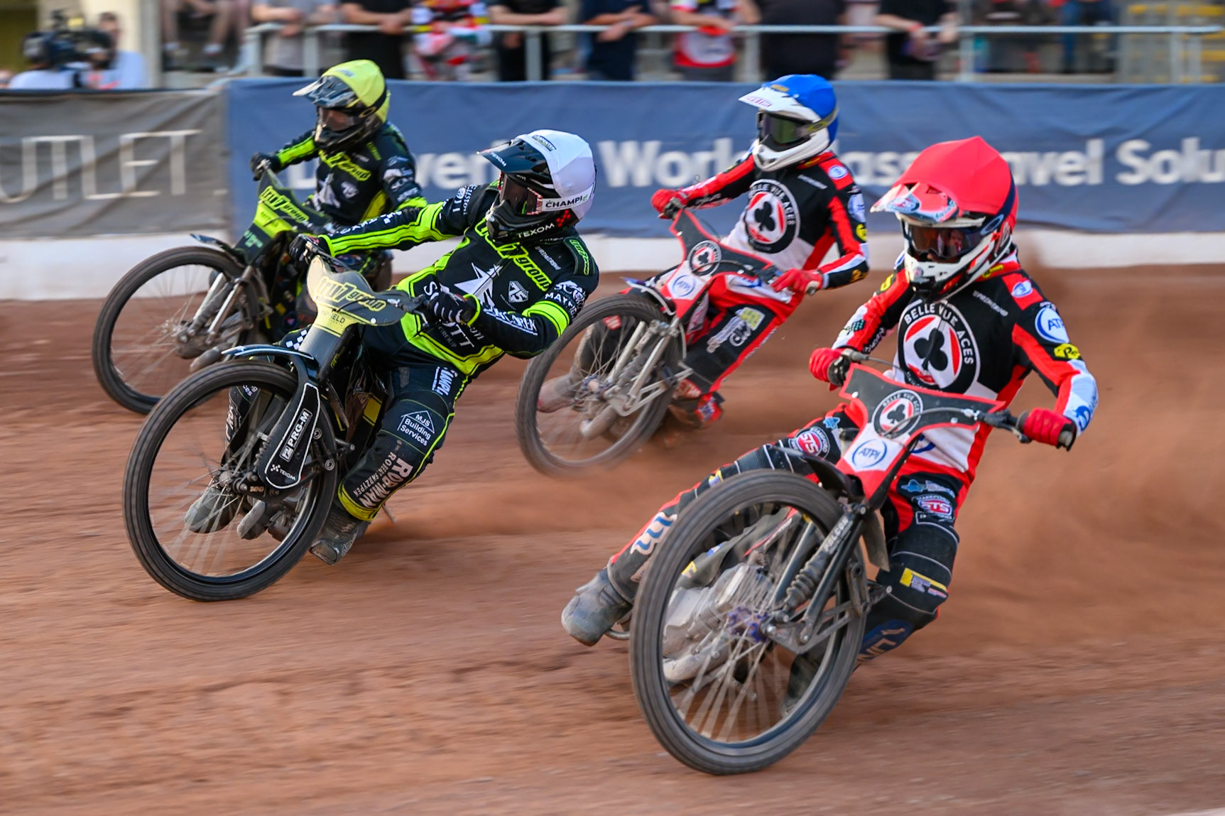 Zach Cook of Belle Vue Aces in Red rides inside Tobiasz Musielak of Ipswich Witches in White, Danny King of Ipswich Witches in Yellow and Peter Kildemand of Belle Vue Aces in Blue during the Rowe Motor Oil Premiership match between Belle Vue Aces and Ipswich Witches at the National Speedway Stadium, Manchester on Saturday 20th June 2026. (Photo: Ian Charles | MI News)
