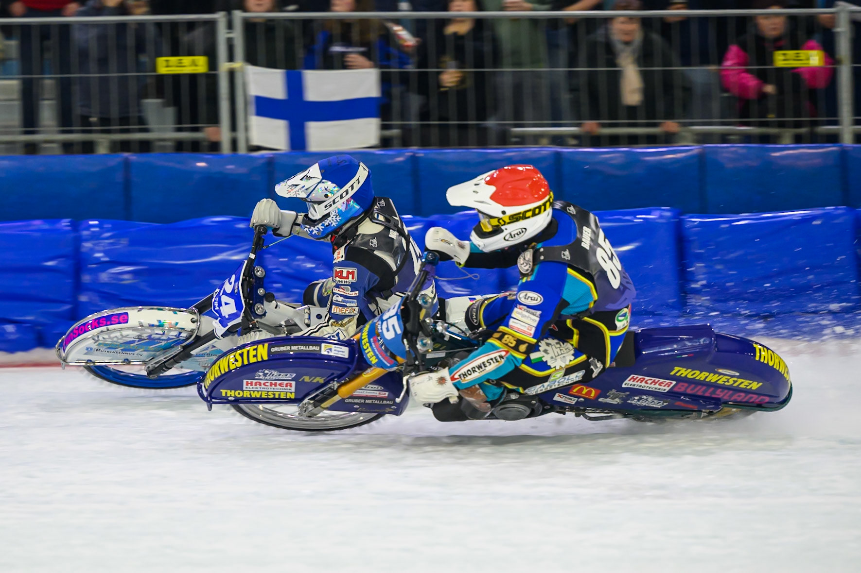 Max Koivula (24) of Finland  in Blue rides outside Luca Bauer (85) of Italy/Germany  in Red during the FIM Ice Speedway Gladiators World Championship Final 3 at Ice Rink Thialf, Heerenveen on Saturday 11th April 2026. (Photo: Ian Charles | MI News)