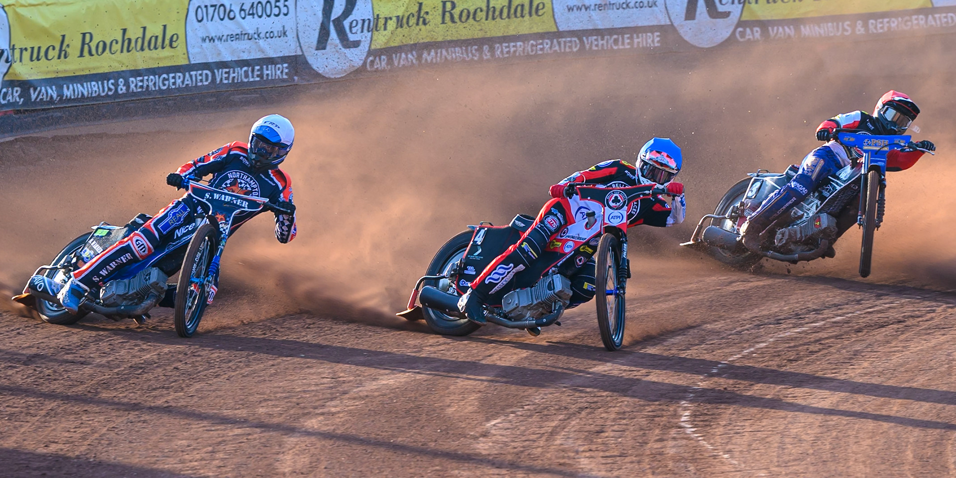 Matej Zagar of Northampton Foxes in White rides outside Zach Cook of Belle Vue Aces  in Blue and Ben Cook, Guest Rider for Belle Vue Aces in Red during the Rowe Motor Oil Premiership match between Belle Vue Aces and Northampton Foxes at the National Speedway Stadium, Manchester on Monday 13th July 2026. (Photo: Ian Charles | MI News)