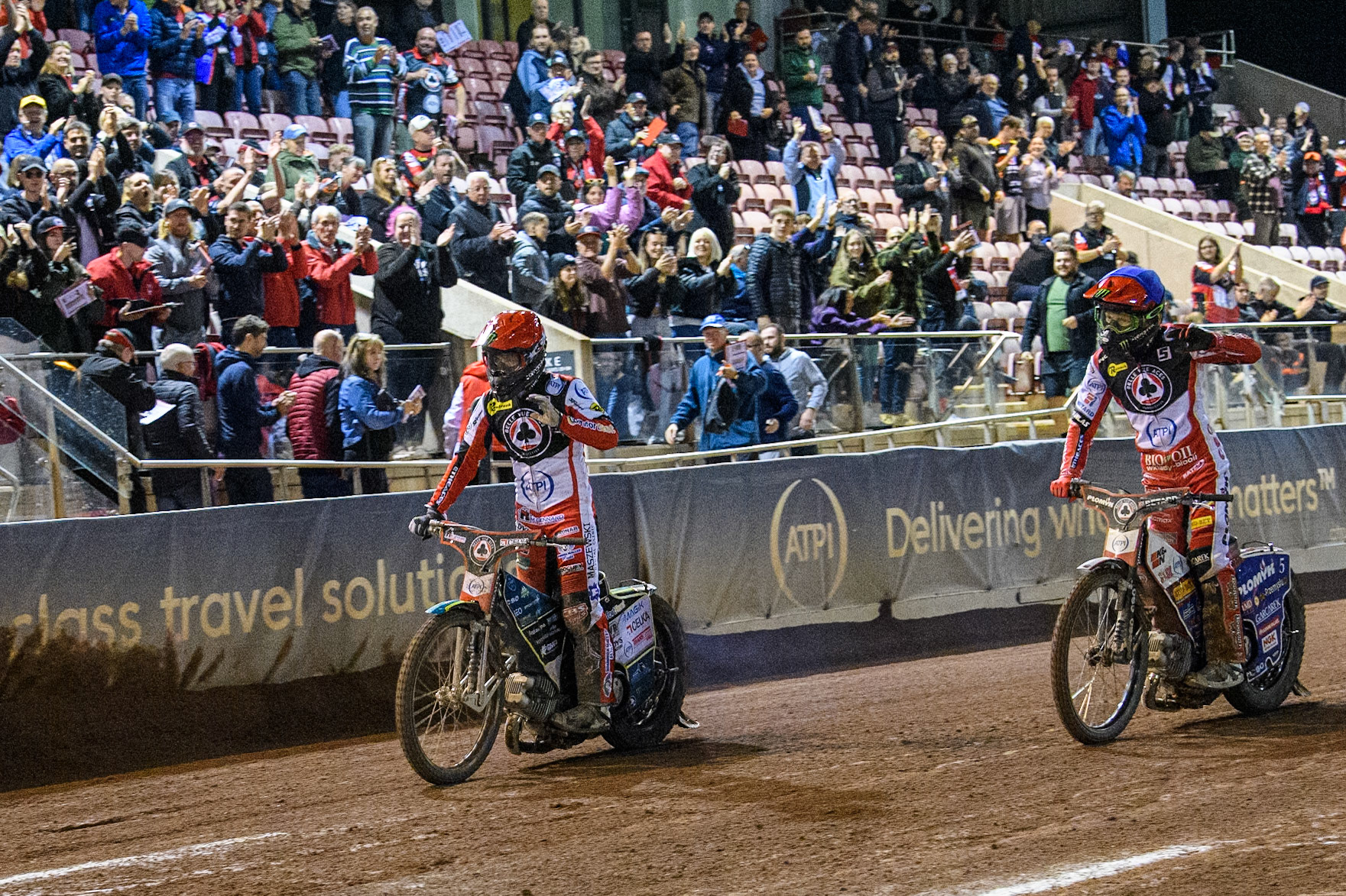 Belle Vue Aces' Jaimon Lidsey  in Red and Belle Vue Aces' Dan Bewley  in Blue acknowledge the crowd on their win in the final heat during the Rowe Motor Oil Premiership Play Off Semi Final 2, 1st Leg match between Belle Vue Aces and Sheffield Tigers at the National Speedway Stadium, Manchester on Monday 16th September 2024. (Photo: Ian Charles | MI News)