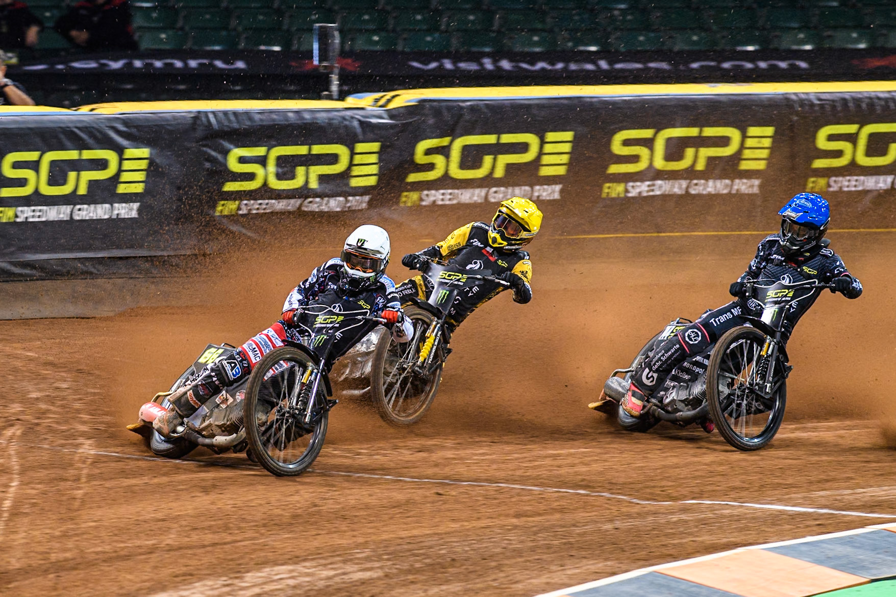 Fredrik Lindgren (66) of Sweden in White leading Szymon Woźniak (48) of Poland in Yellow and Kai Huckenbeck (744) of Germany in Blue during the FIM Speedway Grand Prix of Great Britain at The Principality Stadium, Cardiff on Saturday 17th August 2024. (Photo: Ian Charles | MI News)