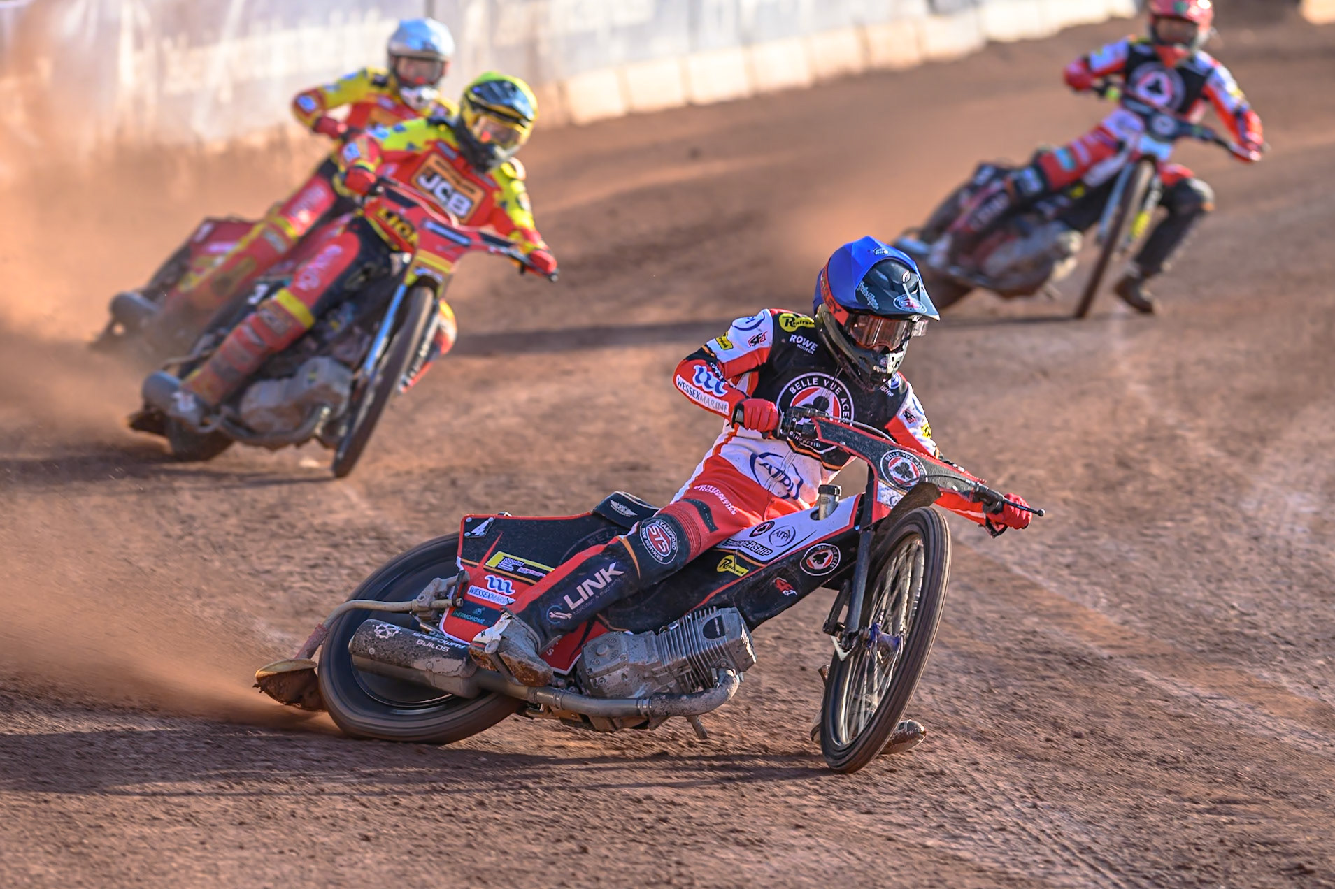 Belle Vue Aces' Zach Cook in Blue leading Leicester Lions' Ryan Douglas in Yellow, Leicester Lions' Max Fricke  in White and Belle Vue Aces' Jaimon Lidsey in Red  during the Rowe Motor Oil Premiership match between Belle Vue Aces and Leicester Lions at the National Speedway Stadium, Manchester on Monday 14th July 2025. (Photo: Ian Charles | MI News)