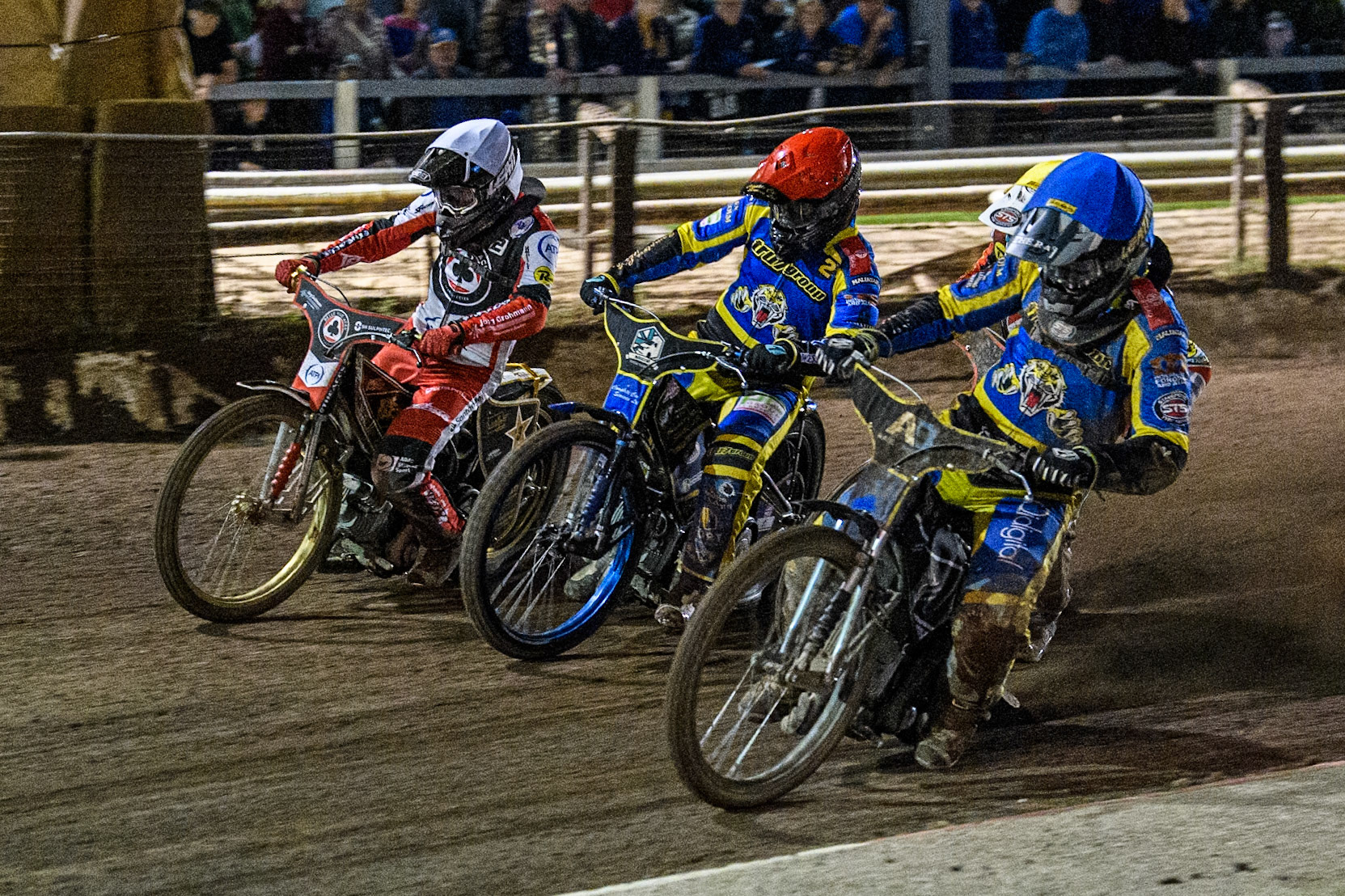Sheffield Tigers' Dan Gilkes  in Blue rides inside Belle Vue Aces' Jake Mulford  in Yellow, Sheffield Tigers' Kyle Howarth  in Red and Belle Vue Aces' Norick Blodorn  in White during the Rowe Motor Oil Premiership Play Off Semi Final 2nd leg between Sheffield Tigers and Belle Vue Aces at Owlerton Stadium, Sheffield on Thursday 19th September 2024. (Photo: Ian Charles | MI News)