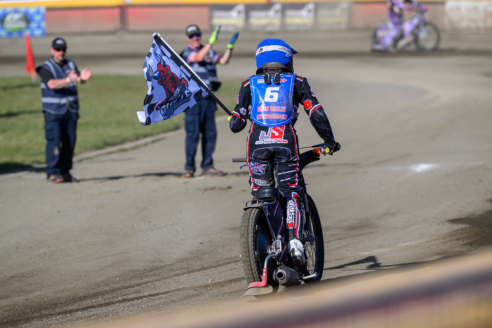 Jack Shimelt of Buxton Bulls  with the club flag after his heat win during the National Development League Challenge match between Buxton Bulls and Stoke Potters at Hi-Edge Speedway, Buxton on Sunday 24th May 2026. (Photo: Ian Charles | MI News)