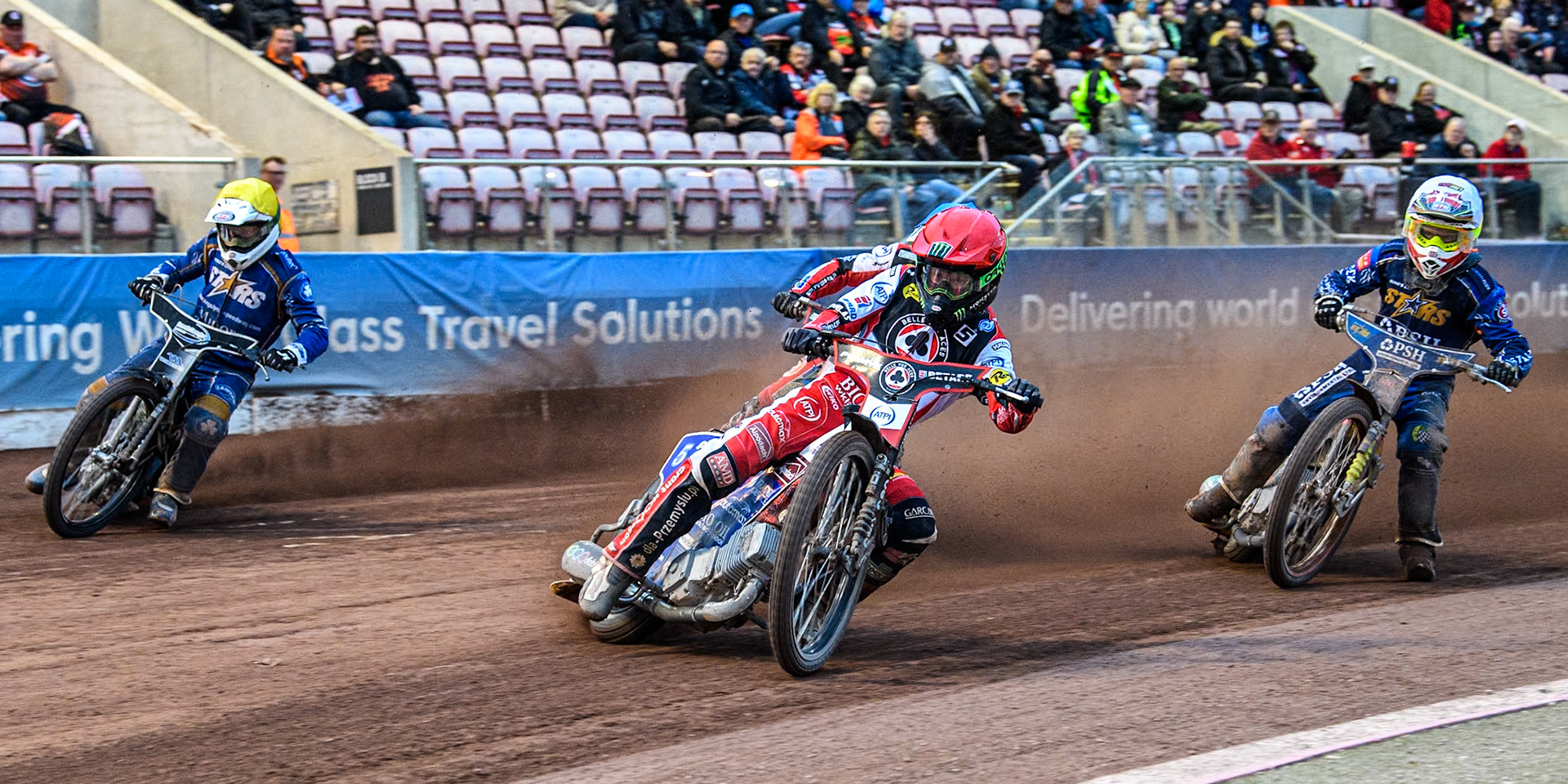 Belle Vue Aces' Dan Bewley in Red leading King Lynn Stars' Michael Palm Toft in White and King Lynn Stars' Guest Richard Lawson in Yellow with Belle Vue Aces' Connor Mountain in Blue behind during the Rowe Motor Oil Premiership match between Belle Vue Aces and King's Lynn Stars at the National Speedway Stadium, Manchester on Monday 20th May 2024. (Photo: Ian Charles | MI News)