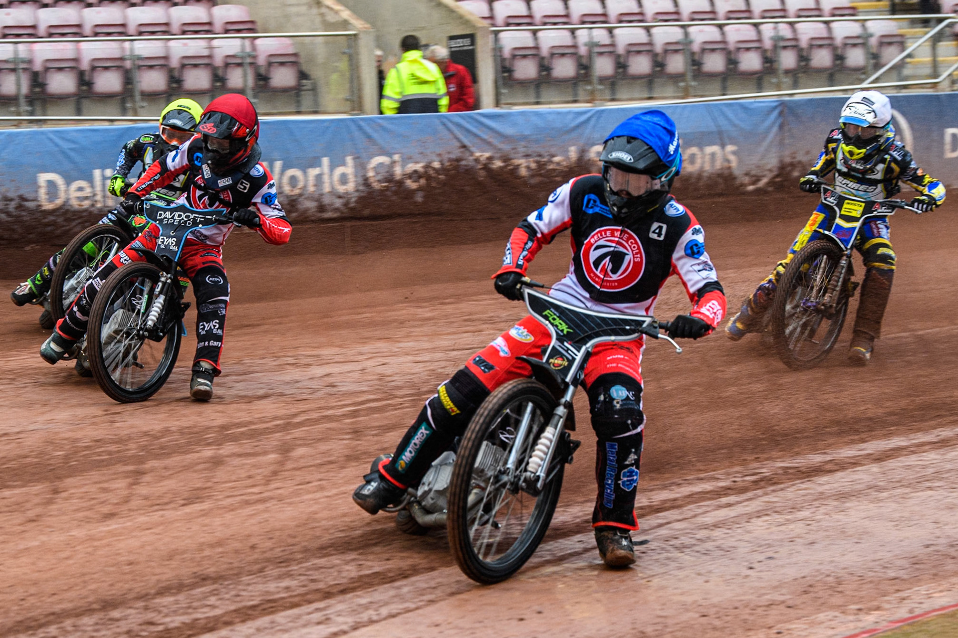 Belle Vue Colts' Matt Marson  in Blue rides inside Belle Vue Colts' Freddy Hodder  in Red, Oxford Chargers' Max Perry  in Yellow and Oxford Chargers' Jamie Etherington  in White behind during the WSRA National Development League match between Belle Vue Colts and Oxford Chargers at the National Speedway Stadium, Manchester on Friday 2nd August 2024. (Photo: Ian Charles | MI News)