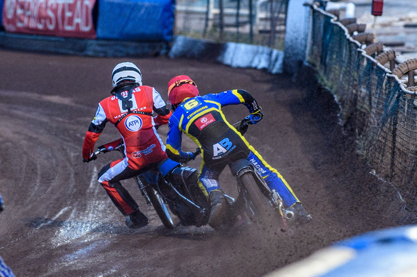 Sheffield Tigers' Jason Edwards  in Red catches his leg on the rear tyre of Belle Vue Aces' Antti Vuolas in White during the Rowe Motor Oil Premiership match between Sheffield Tigers and Belle Vue Aces at Owlerton Stadium, Sheffield on Monday 26th August 2024. (Photo: Ian Charles | MI News)
