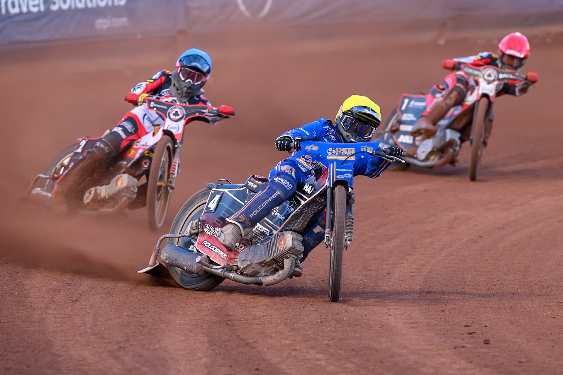 Ben Cook of Kings Lynn Stars in Yellow leading Norick Blödorn of Belle Vue Aces in Blue and Brady Kurtz of Belle Vue Aces in Red during the Rowe Motor Oil Premiership match between Belle Vue Aces and King's Lynn Stars at the National Speedway Stadium, Manchester on Monday 10th August 2026. (Photo: Ian Charles | MI News)