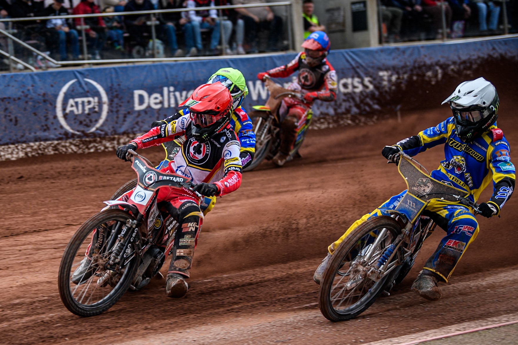 Dan Bewley of Belle Vue Aces in Red leading Jack Holder of Sheffield Tigers in White, Leon Flint of Sheffield Tigers in Yellow and Tate Zischke of Belle Vue Aces in Blue  during the Rowe Motor Oil Premiership match between Belle Vue Aces and Sheffield Tigers at the National Speedway Stadium, Manchester on Monday 5th May 2025. (Photo: Ian Charles | MI News)