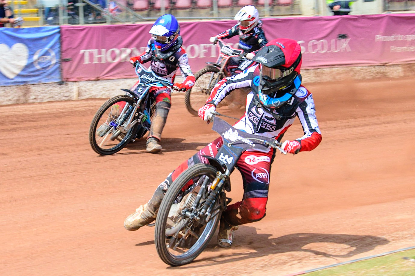 MANCHESTER, UK.  JUN 3RD  Harry McGurk  (Red) leads team mate Freddy Hodder  (Blue) and Oxford Chargers  Sam Hagon  (White) during the National Development League match between Belle Vue Colts and Oxford Chargers at the National Speedway Stadium, Manchester on Friday 3rd June 2022. (Credit: Ian Charles | MI News)